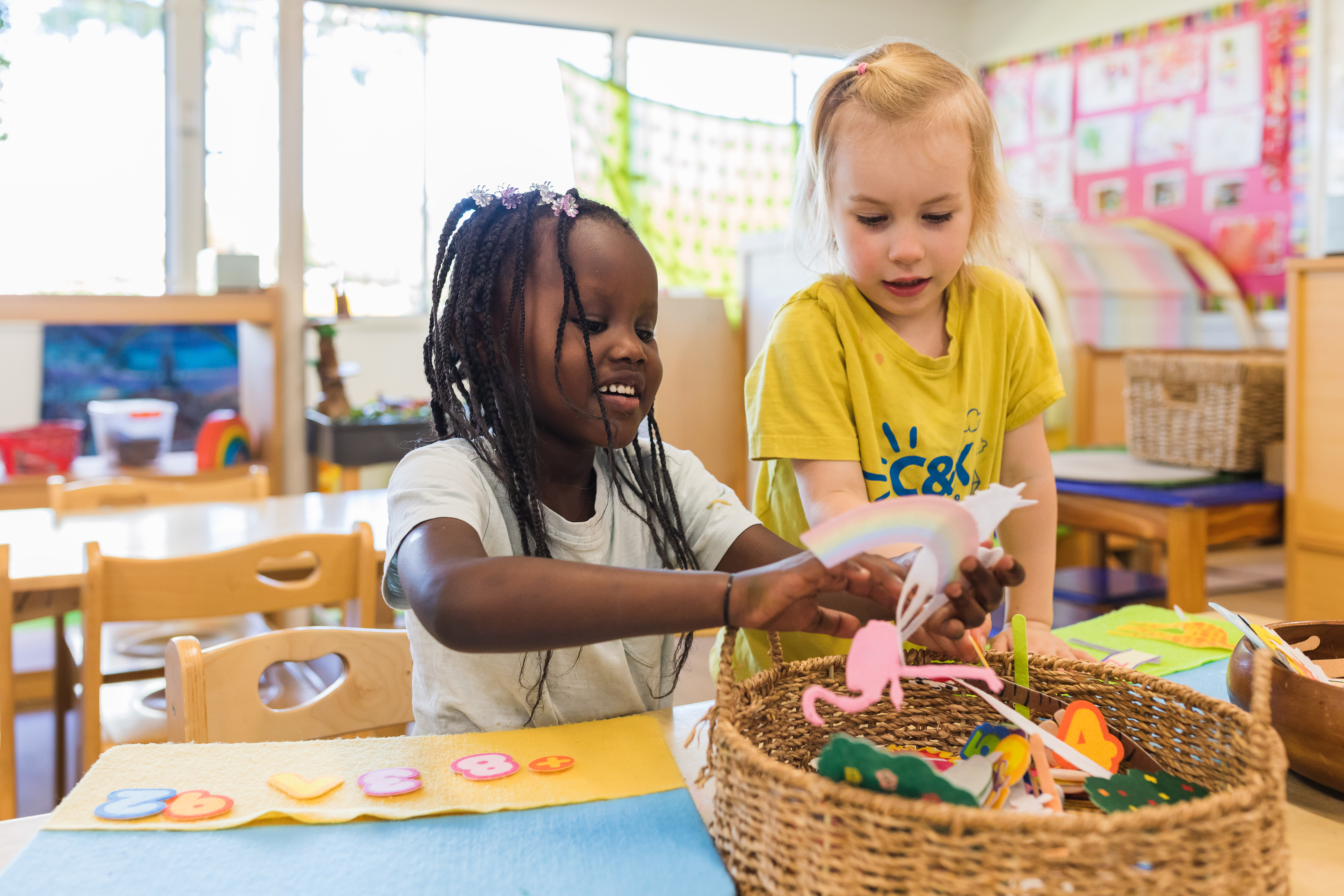 two children doing craft inside