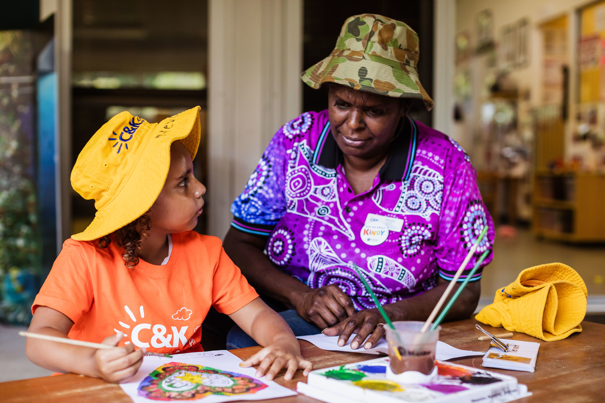C&K educator and child painting