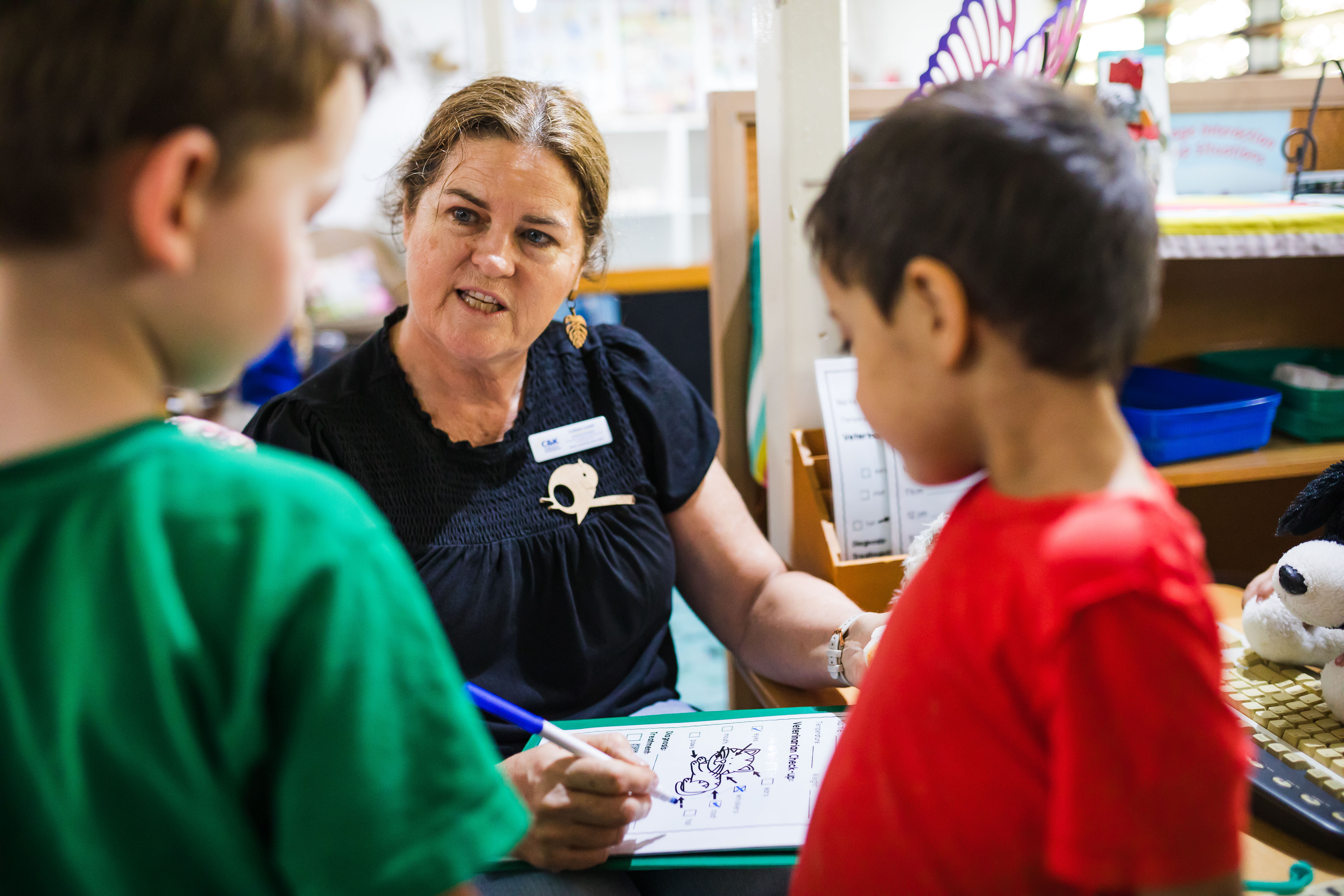 Teacher and children playing vets