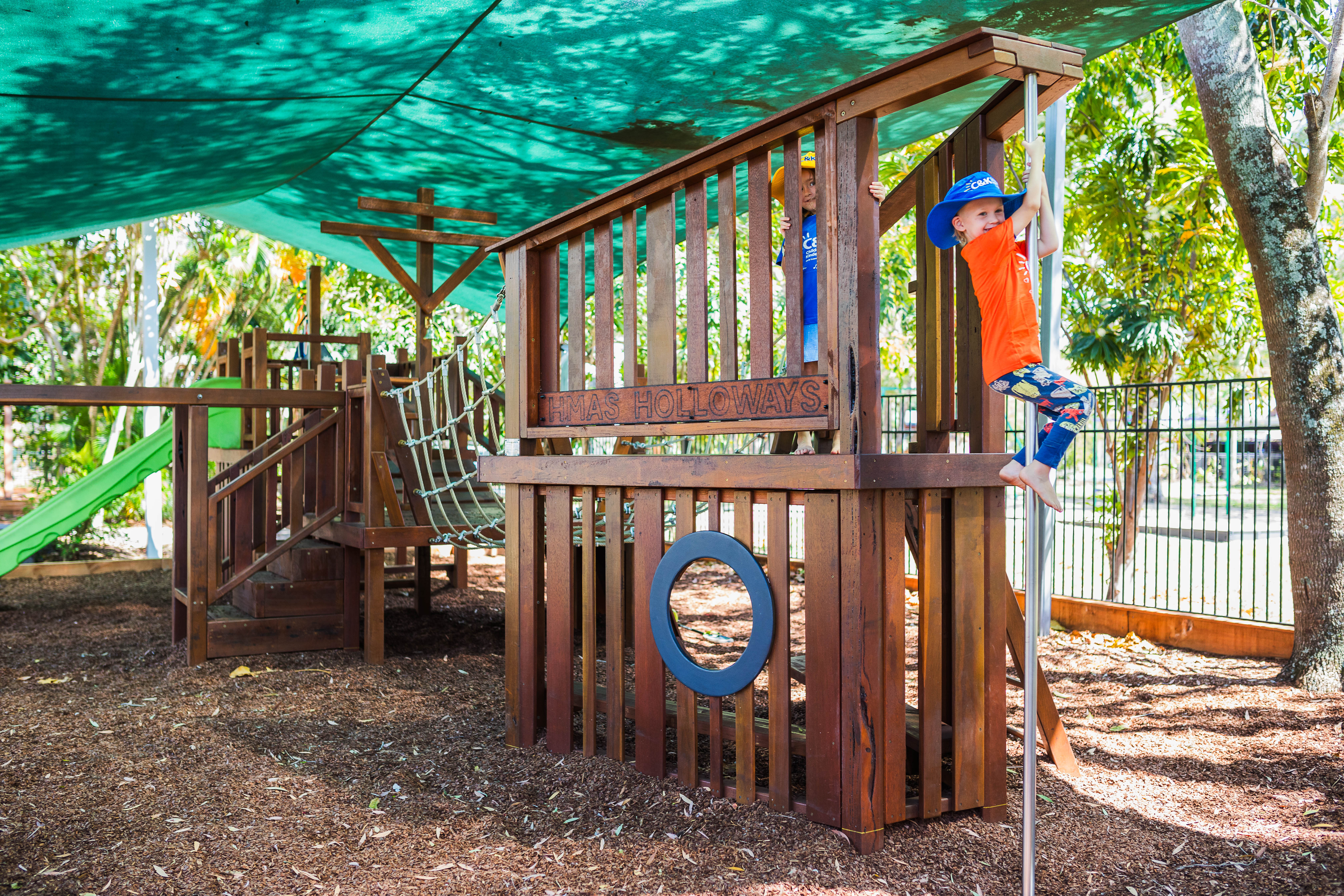 Kindy child sliding down fire pole