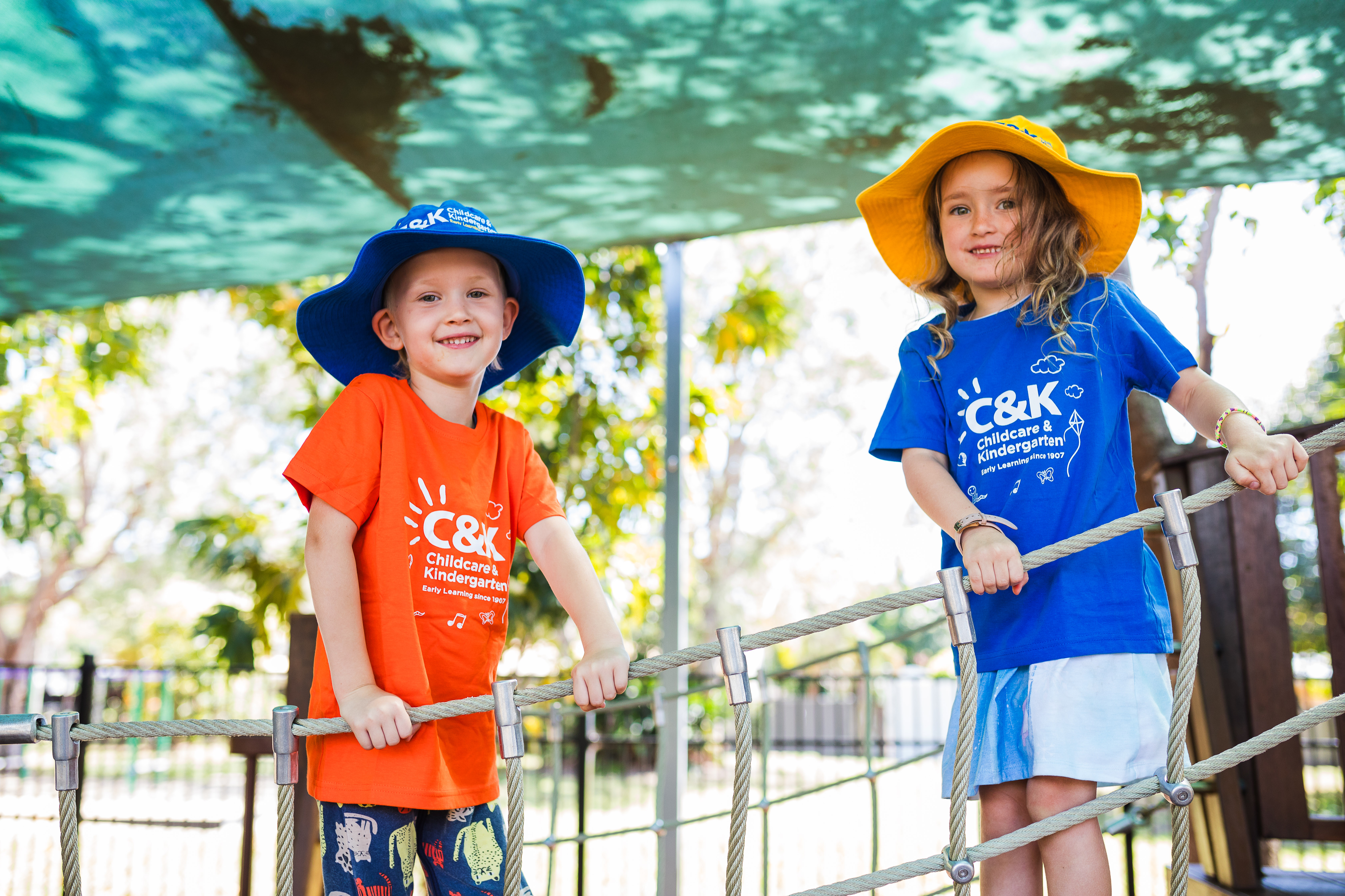 Two kindy children playing on playground