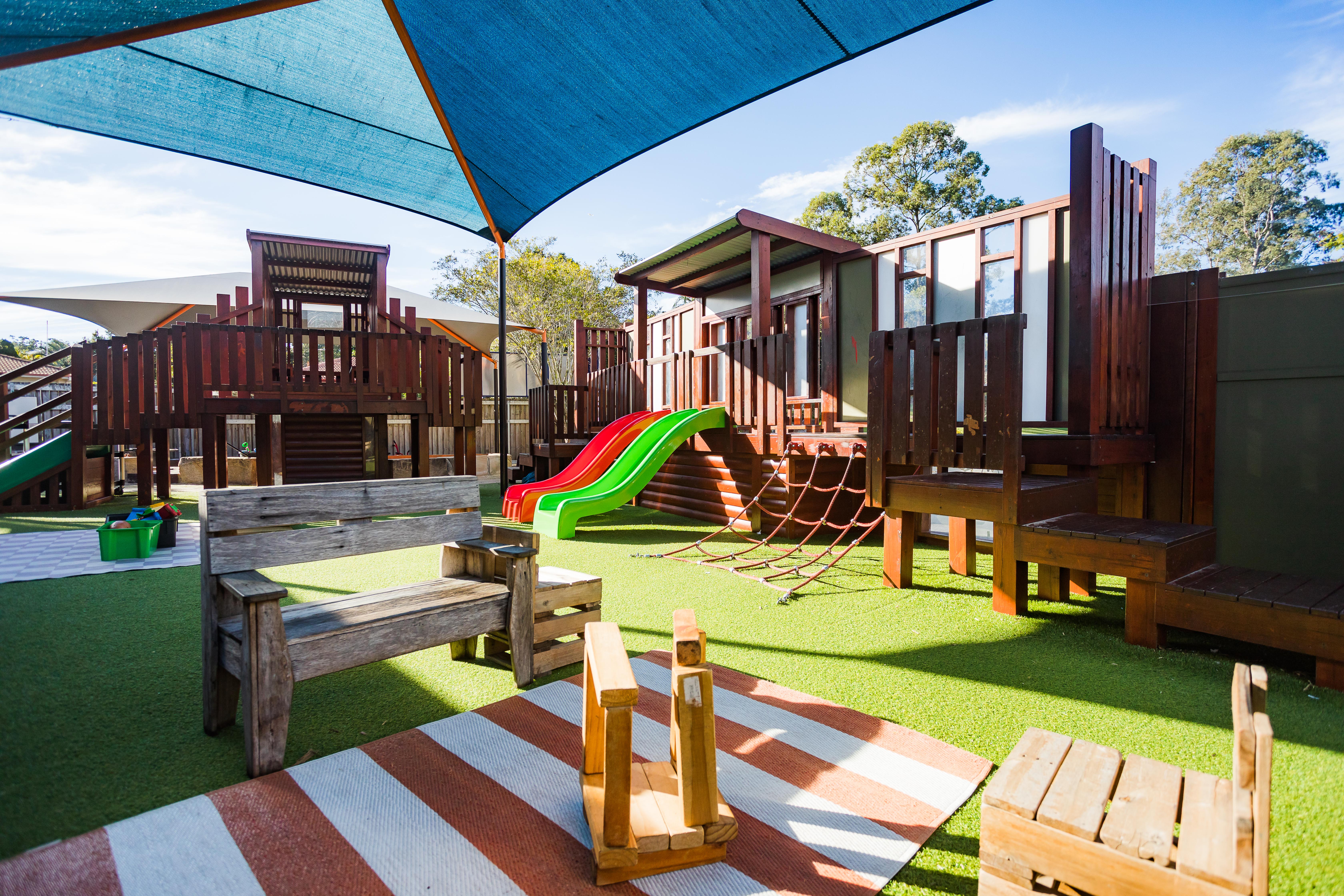 Large wooden playground area that is shaded