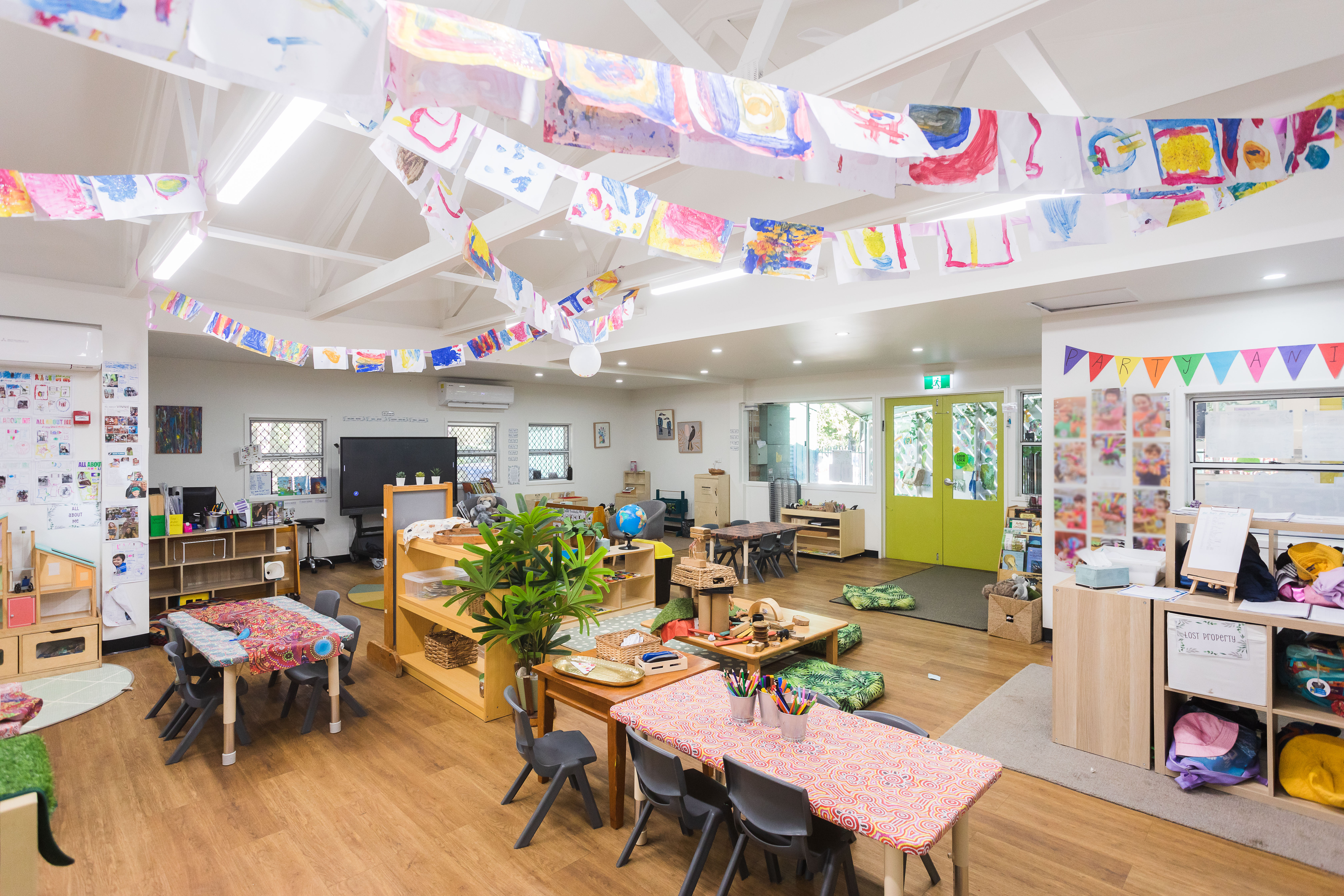 Childcare indoor area with furniture and artwork hanging