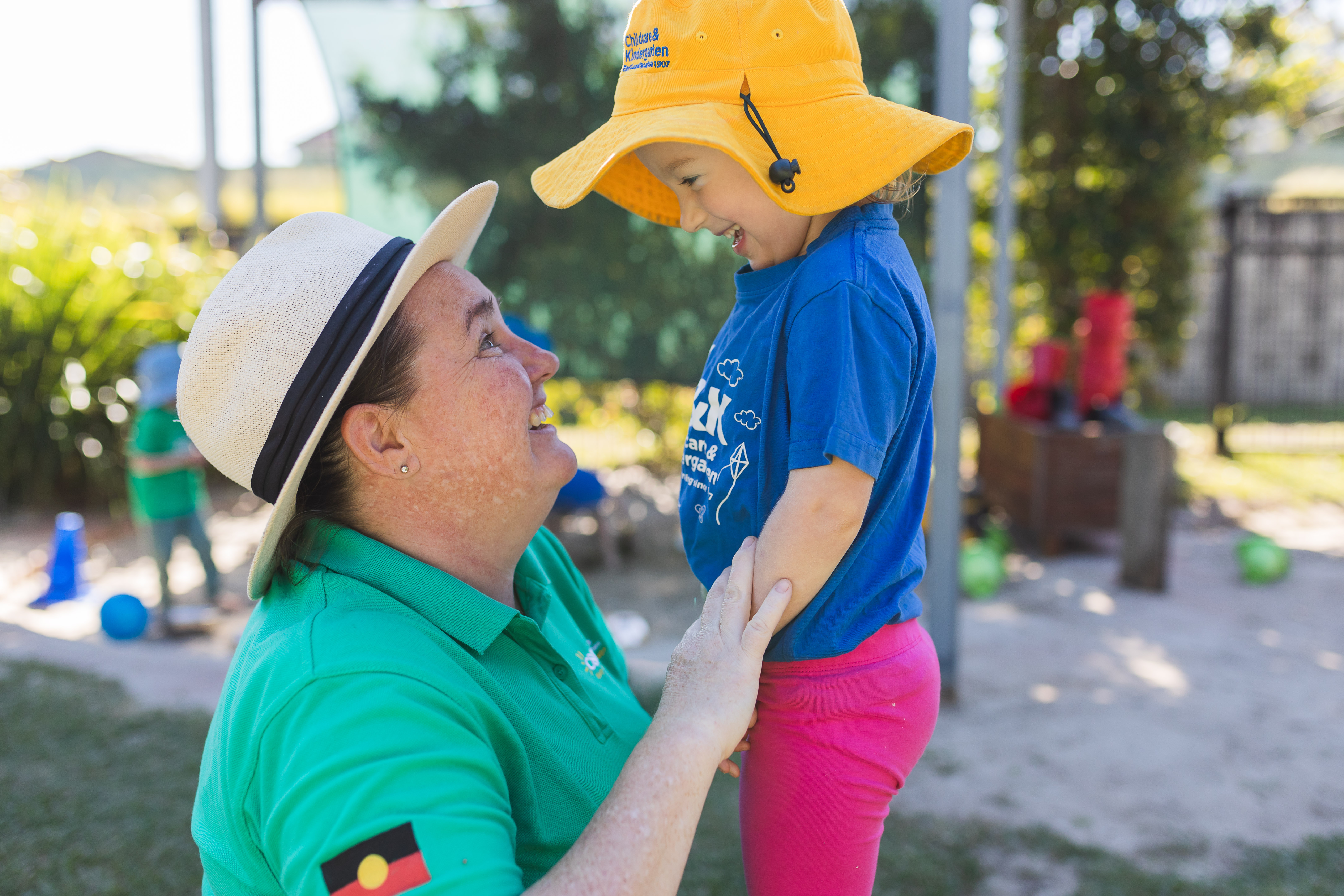 child and educator smiling at each other