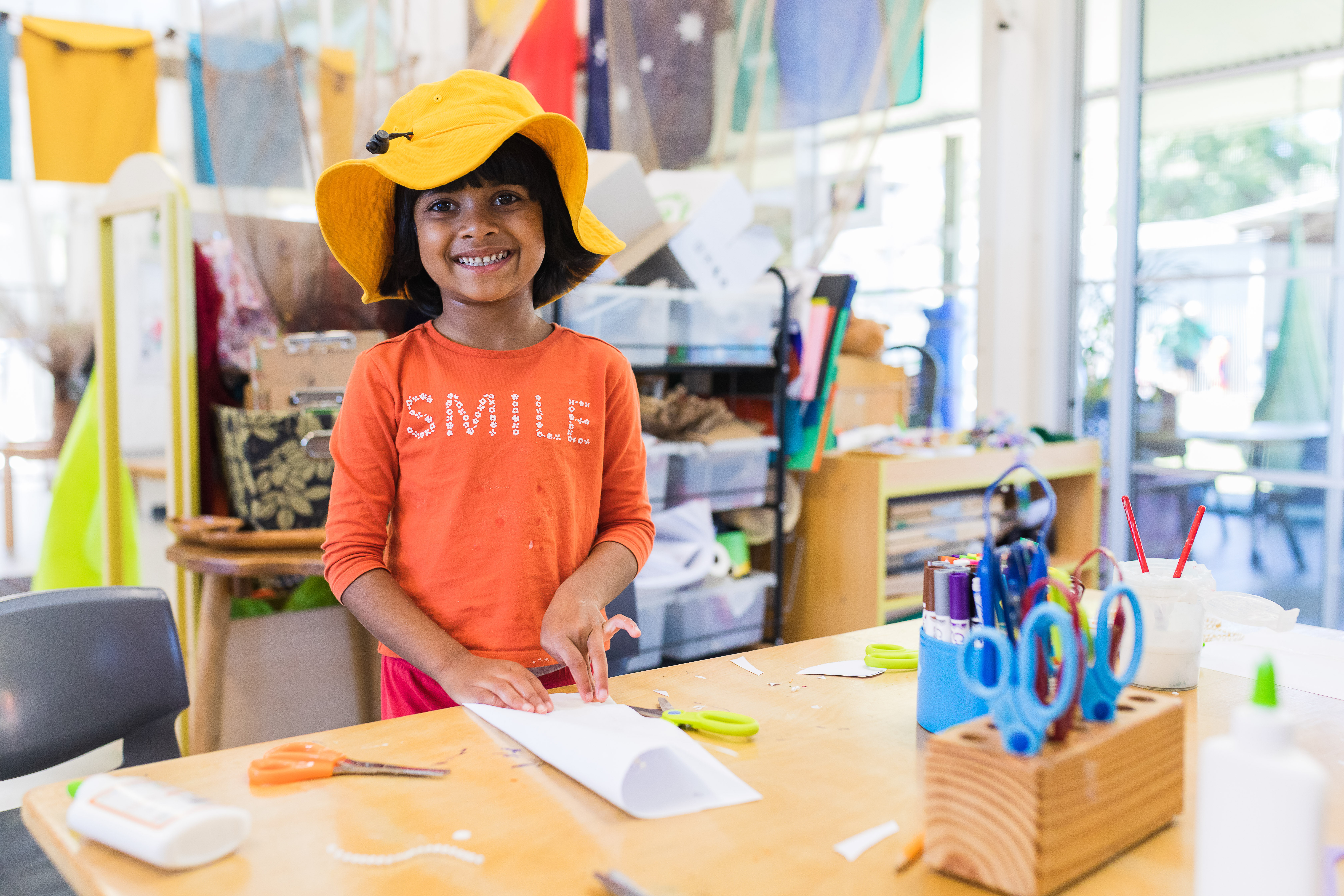 Child doing activity inside smiling