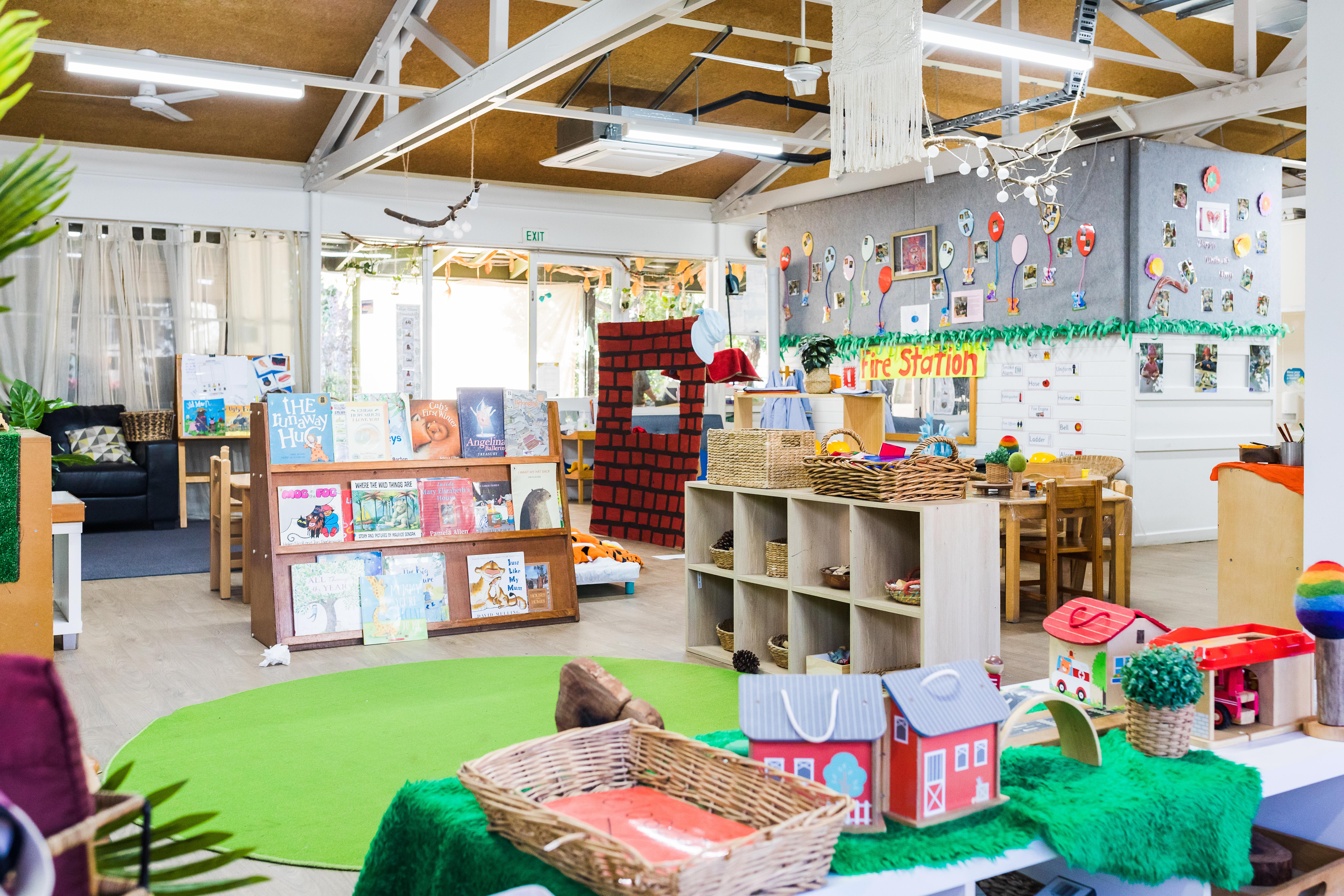 Inside childcare centre with artwork handing and books displayed