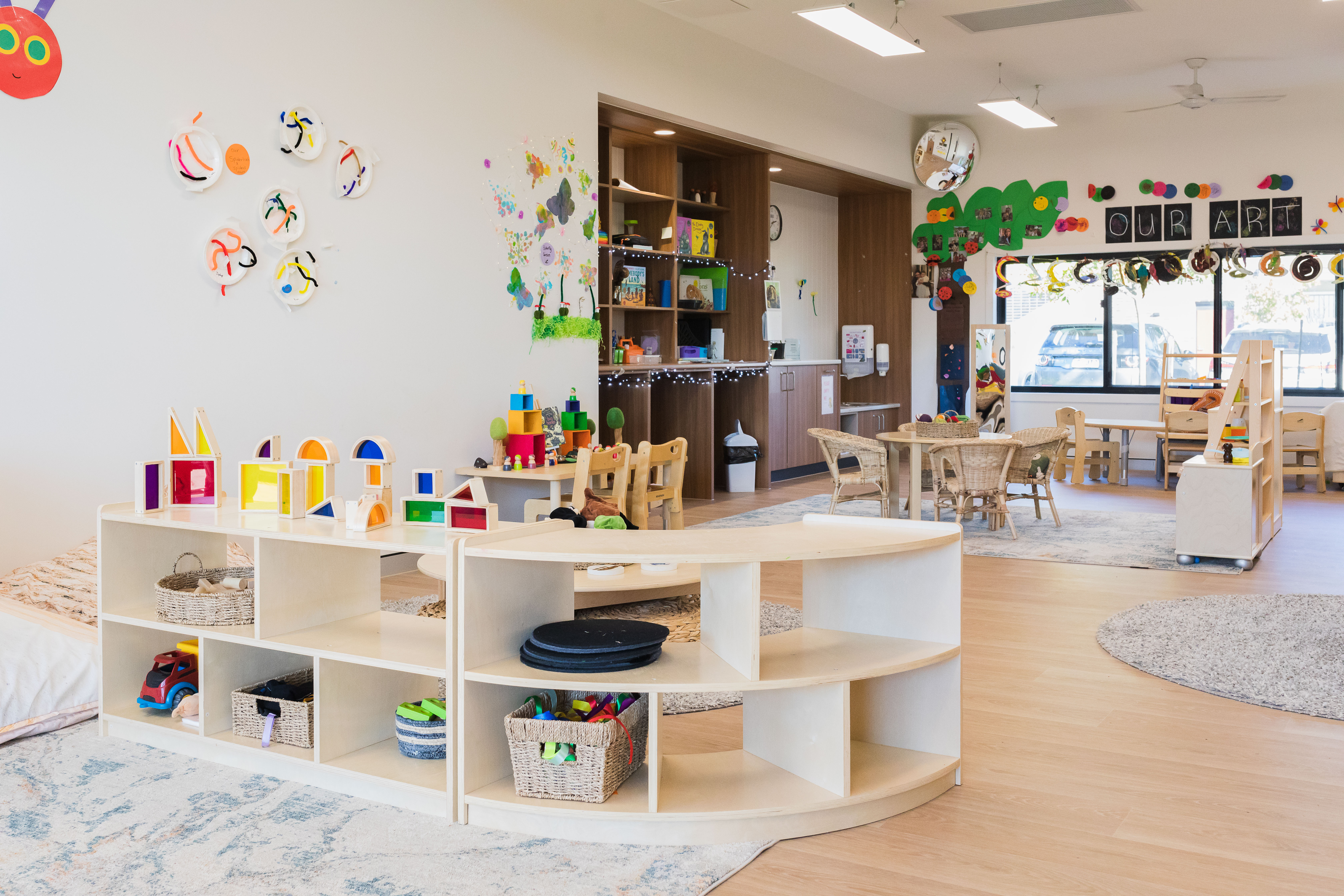 inside childcare centre with low furniture and toys