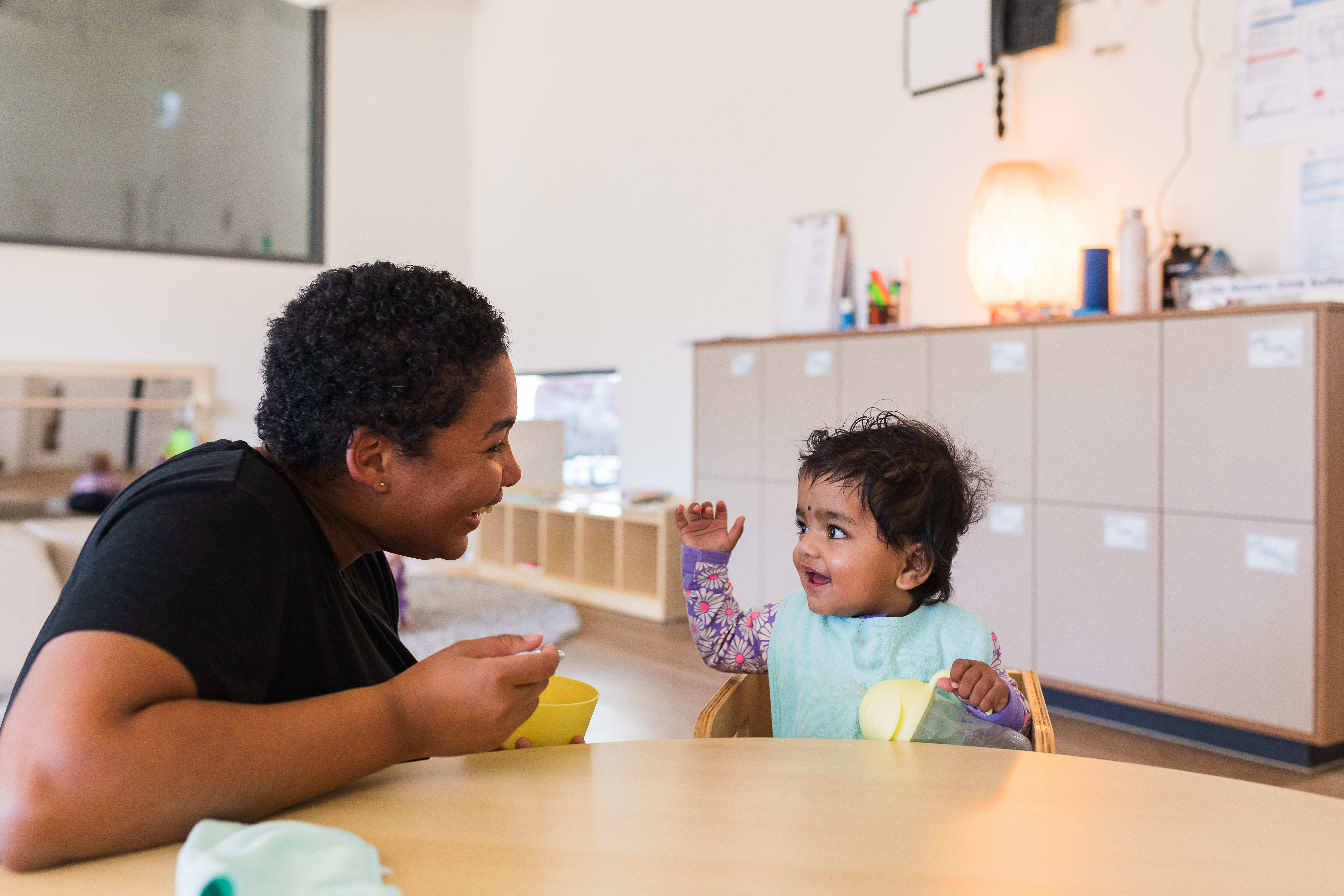 educator feeding baby