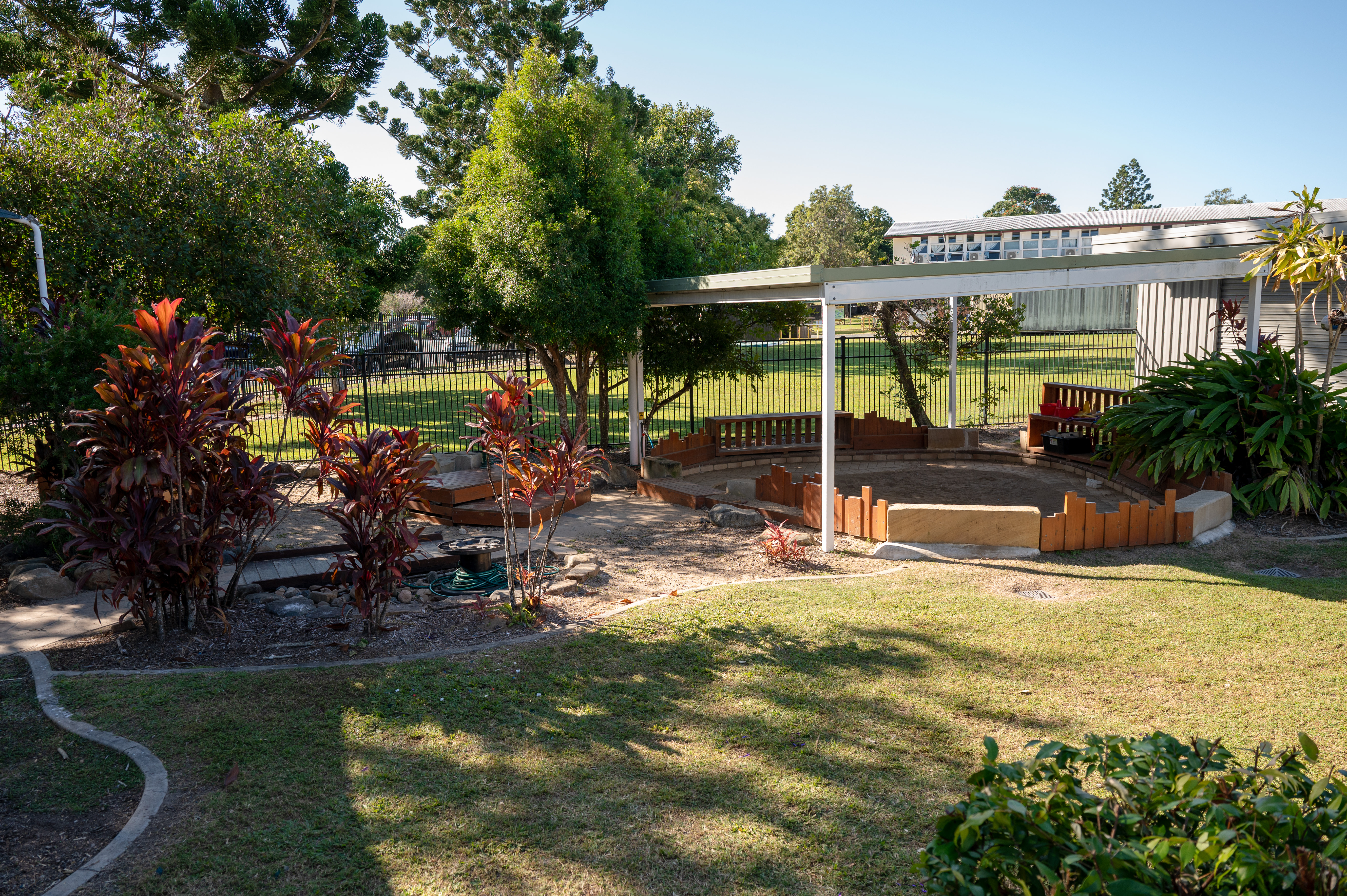 outdoor area with sandpit and garden