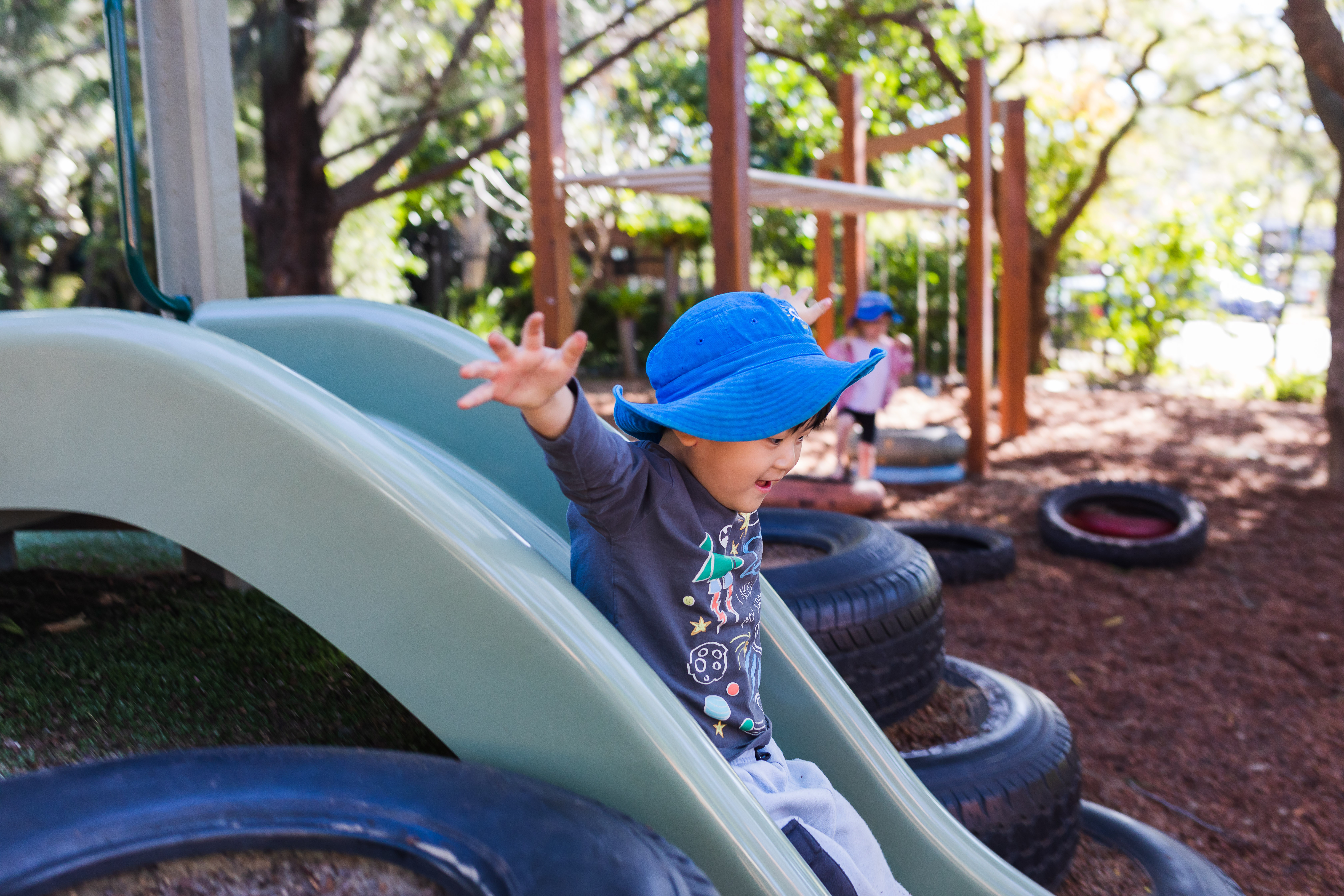 child going down slide