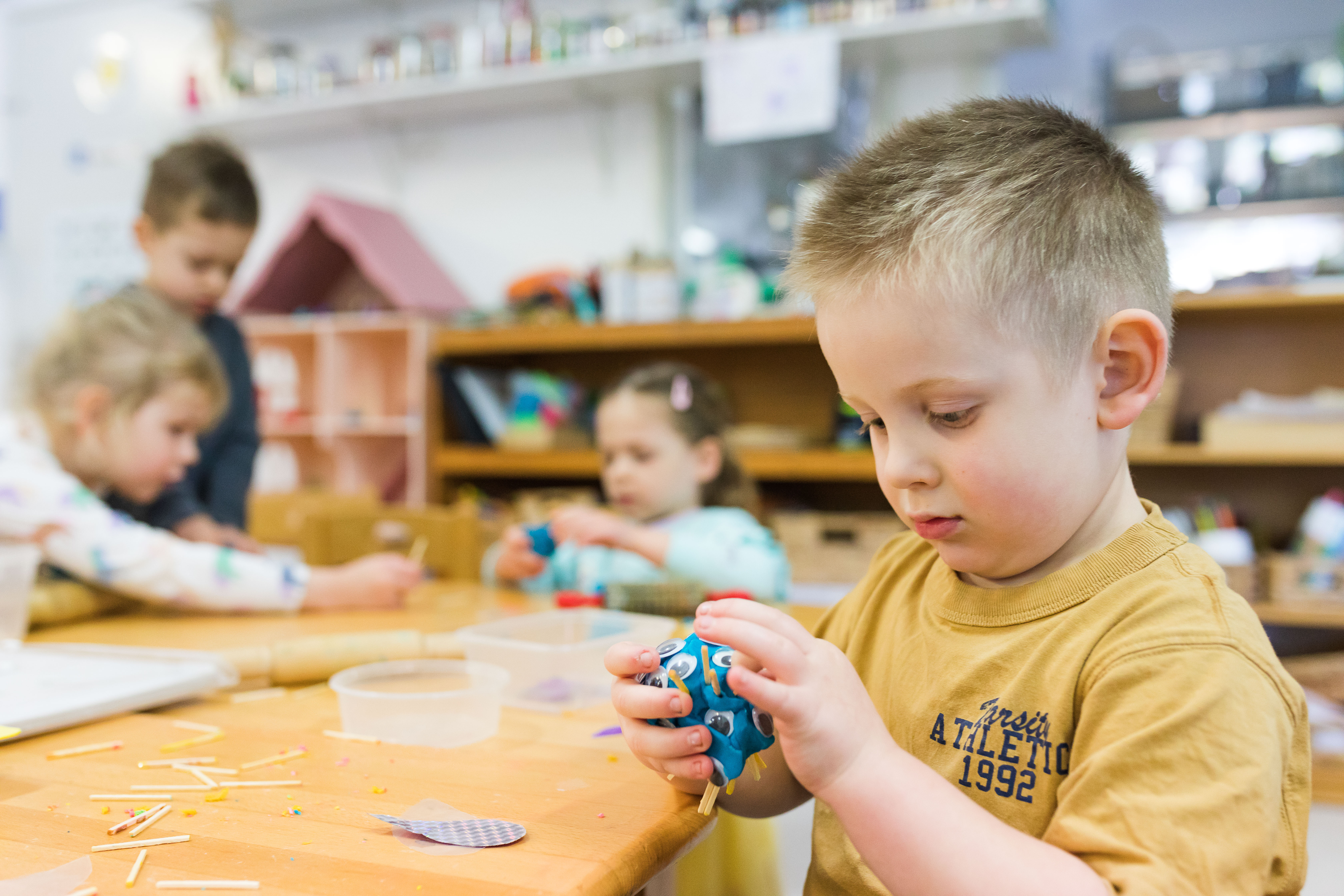 children inside playing with craft