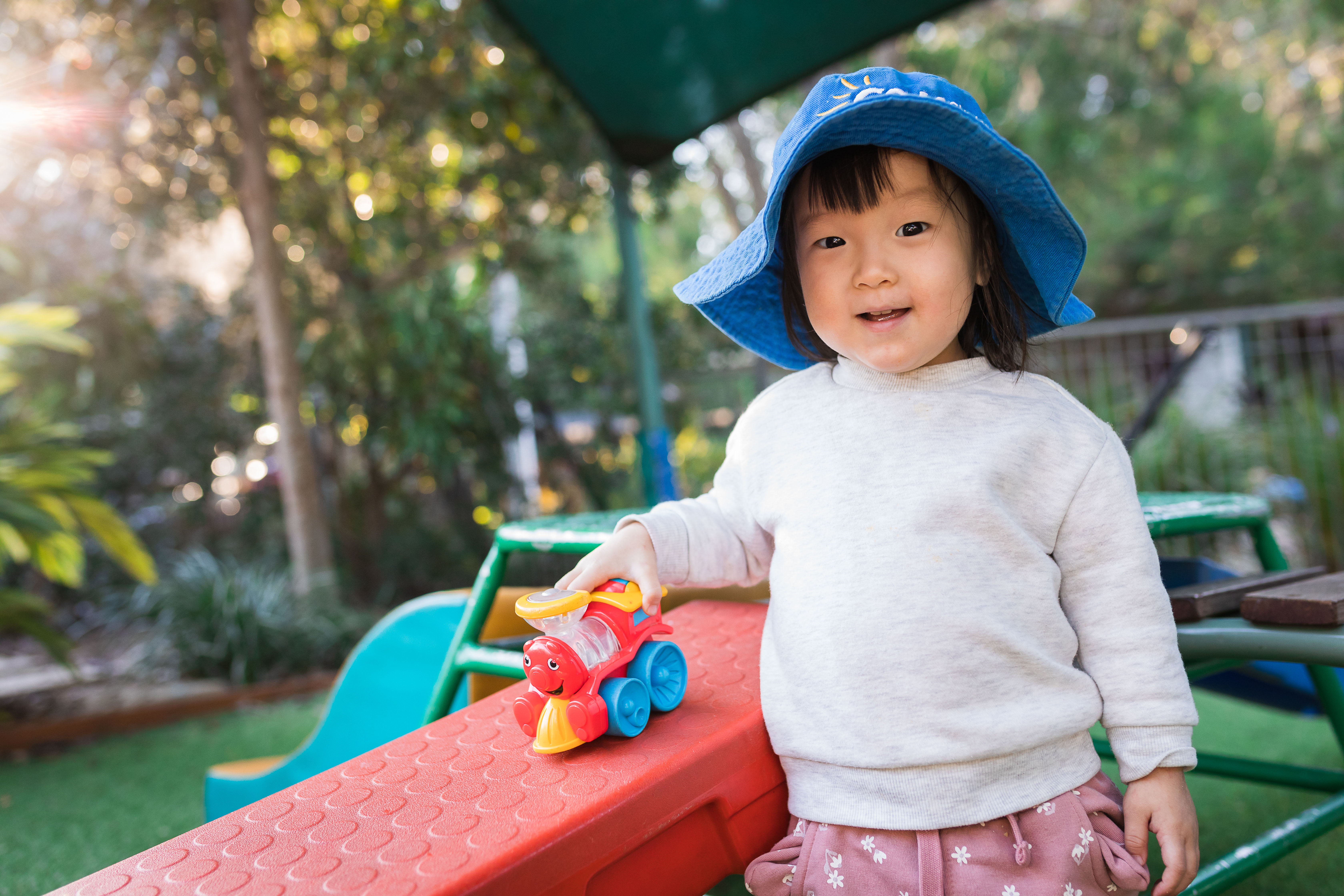 Child playing with toy outside