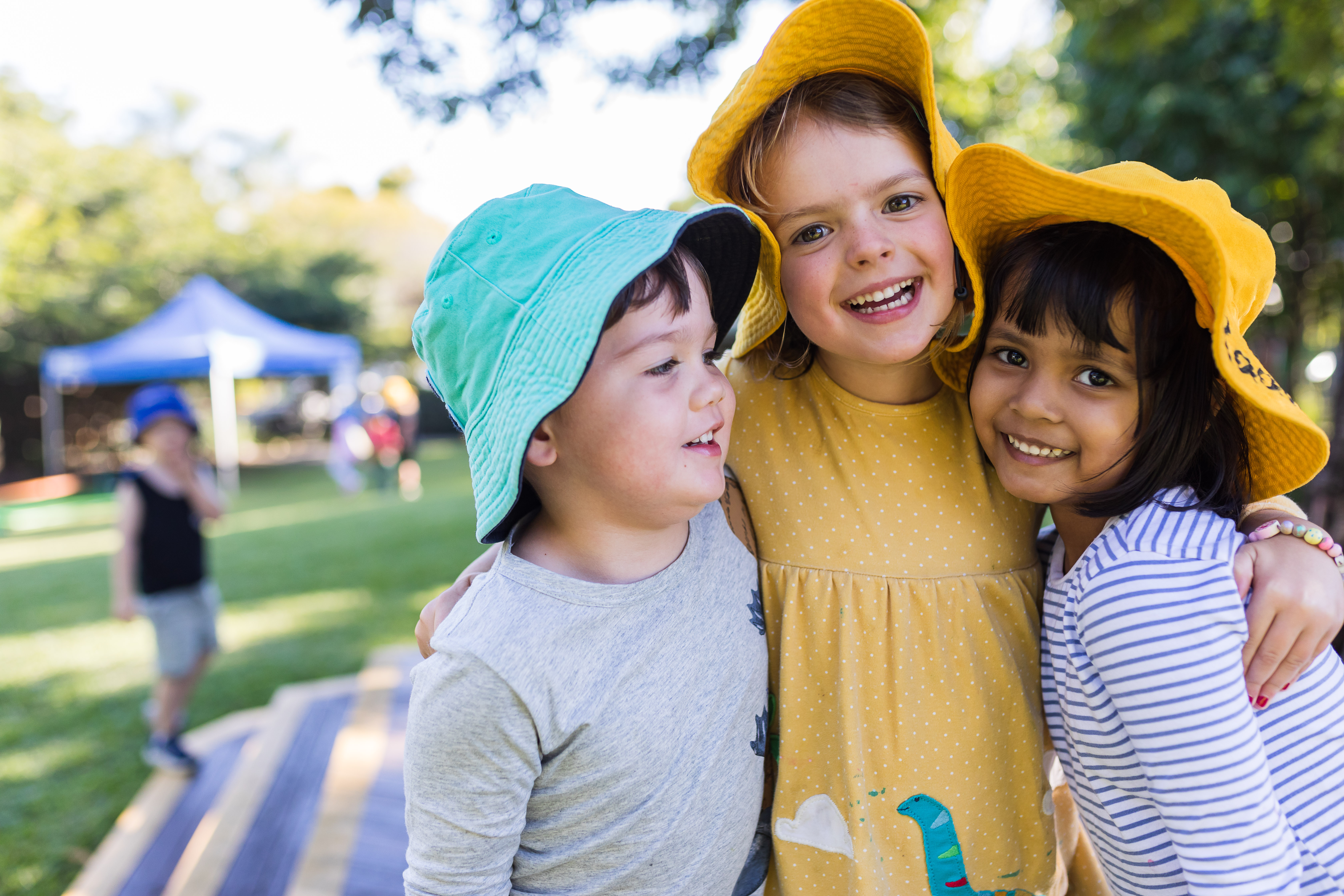 three children embracing and smiling