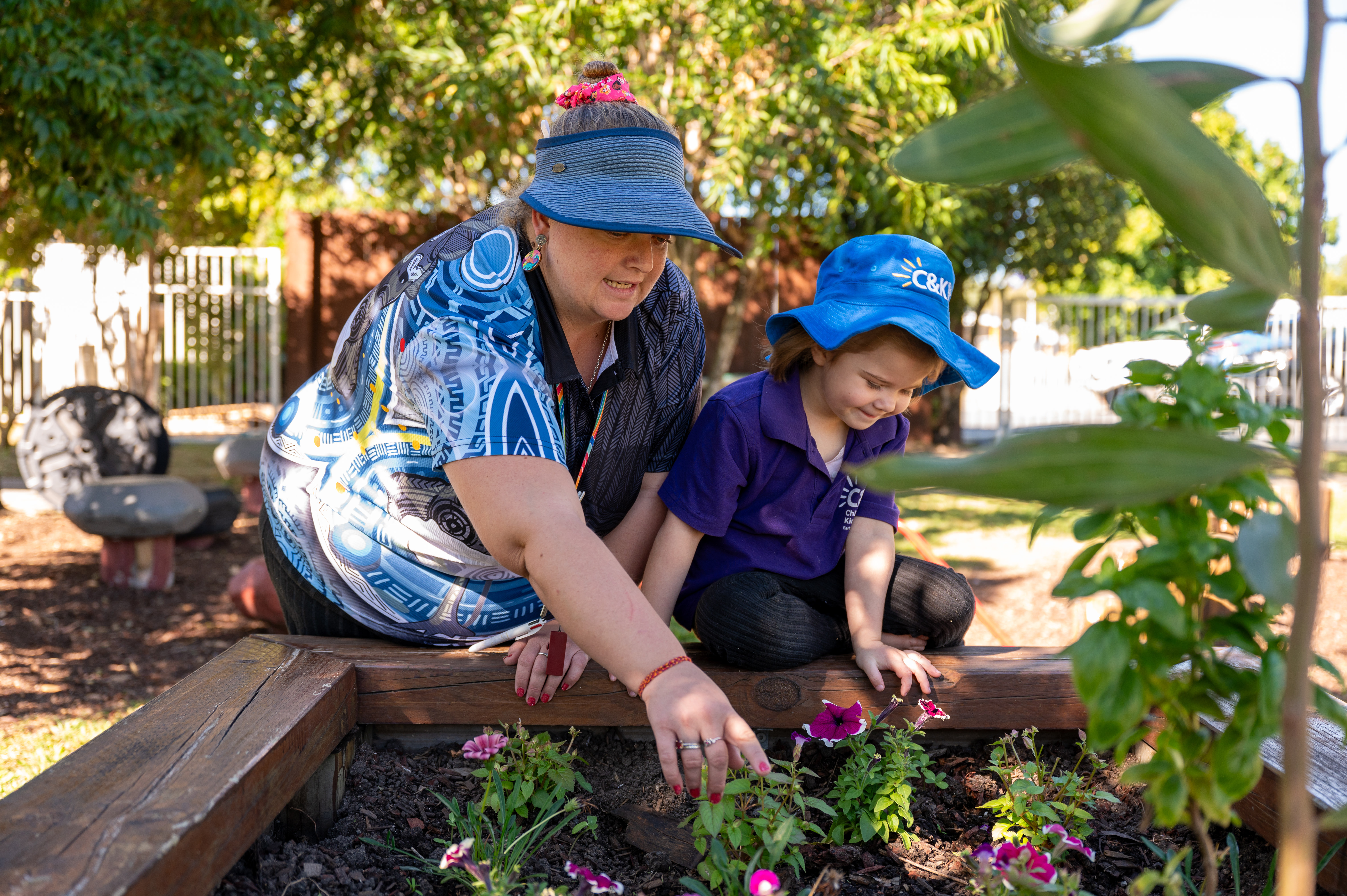 educator and child in garden together