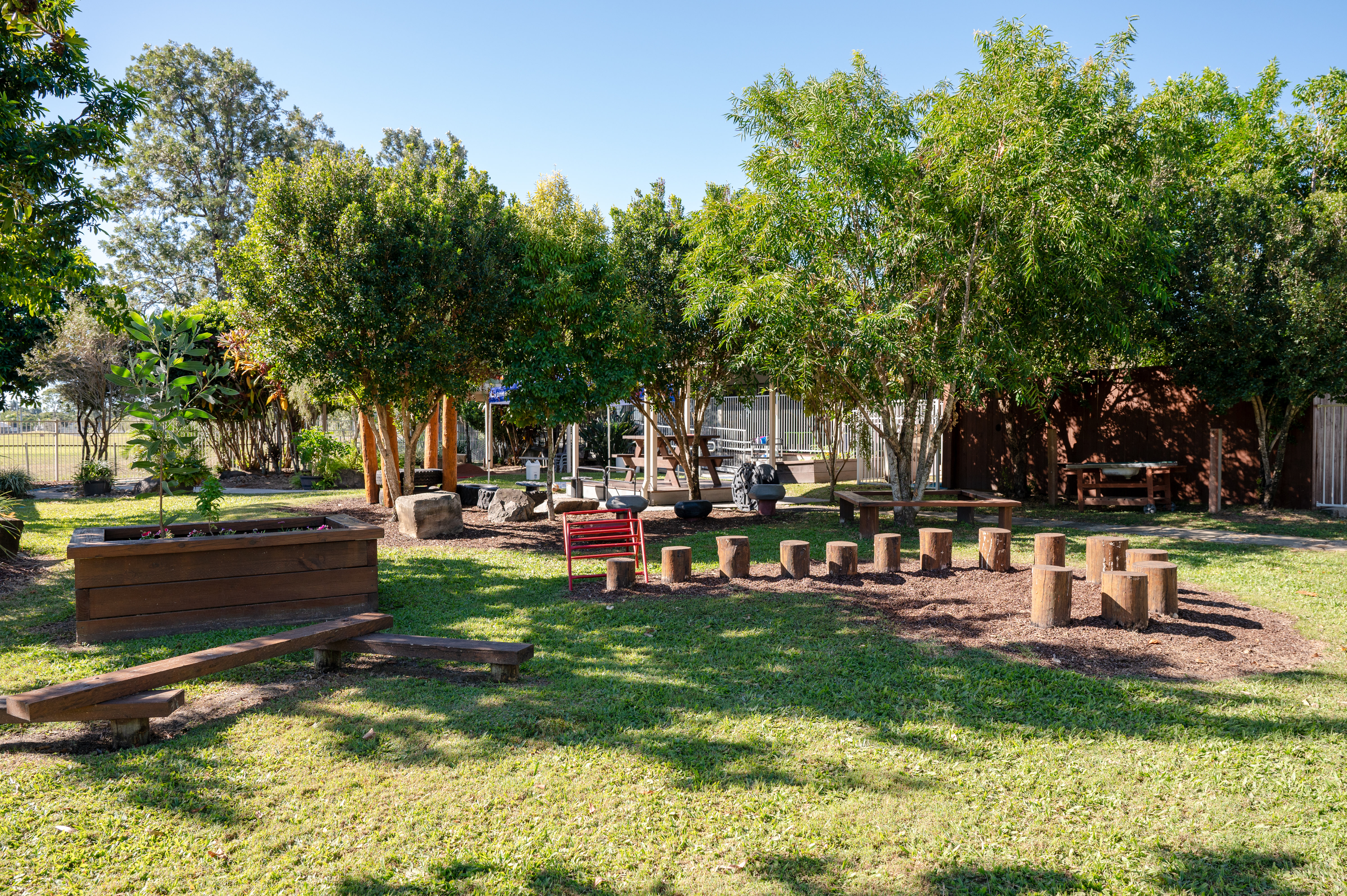 Image of the outdoor area including obstacle course and trees