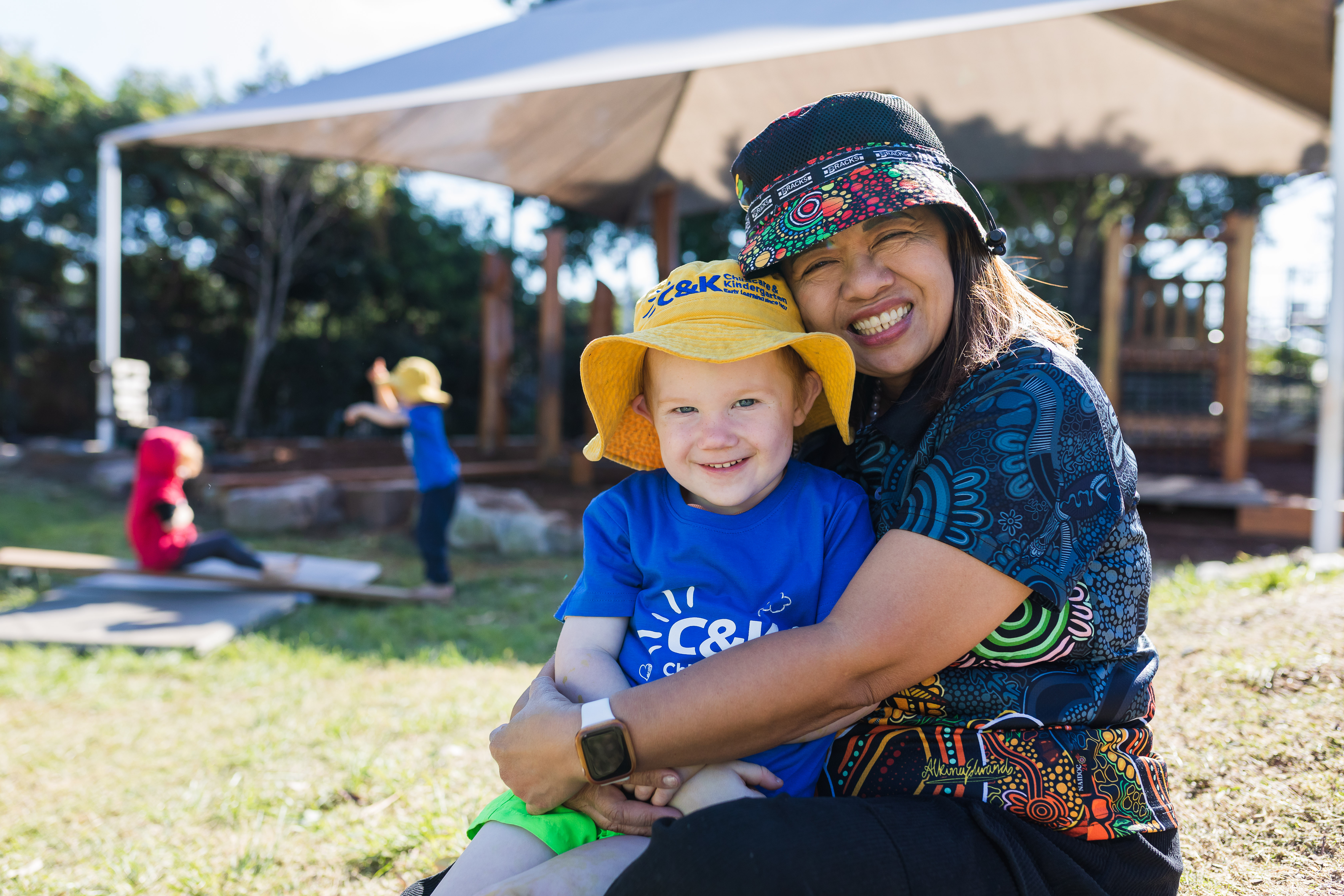 educator and child outside smiling