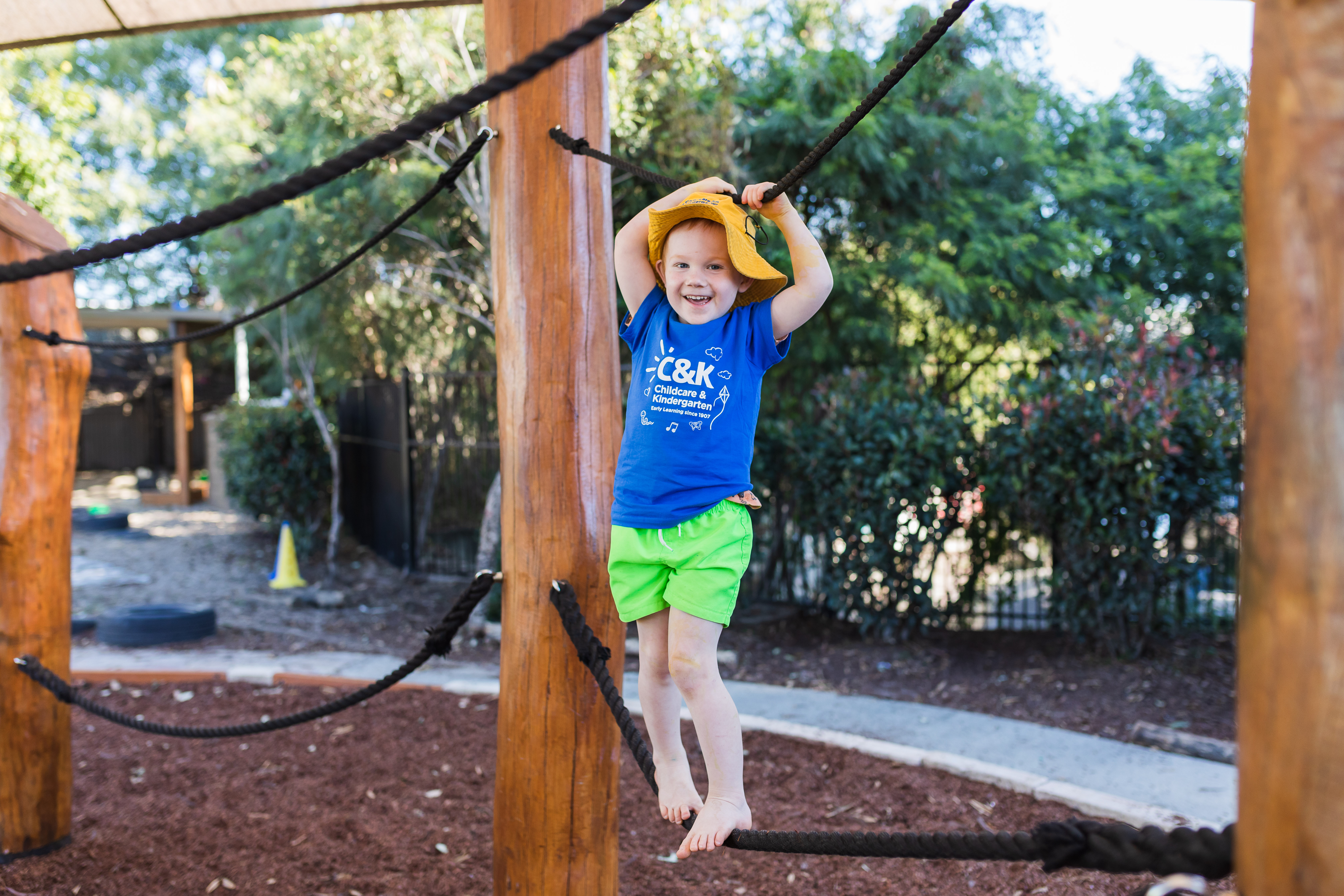child on playground smiling