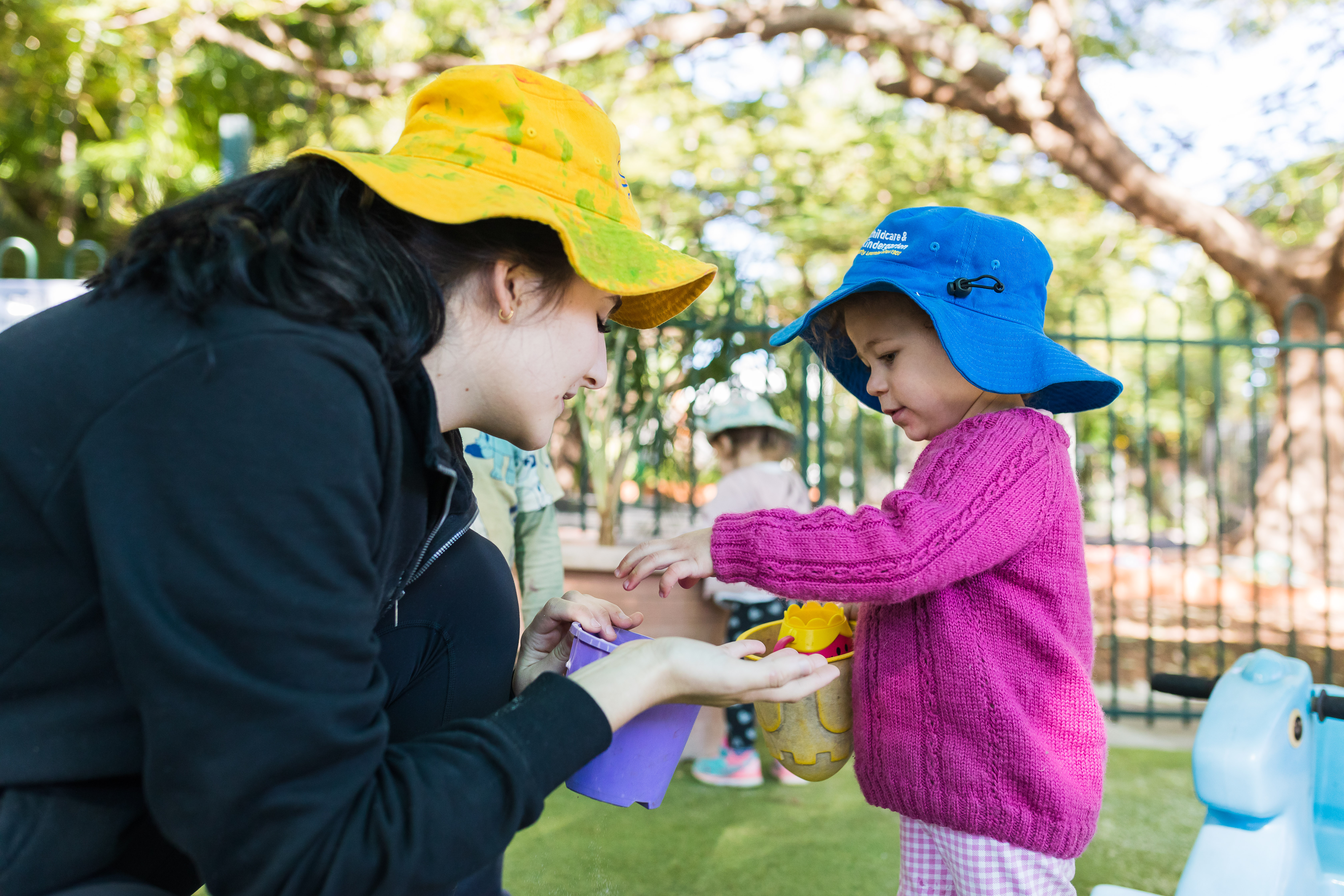 toddler and educator together outside