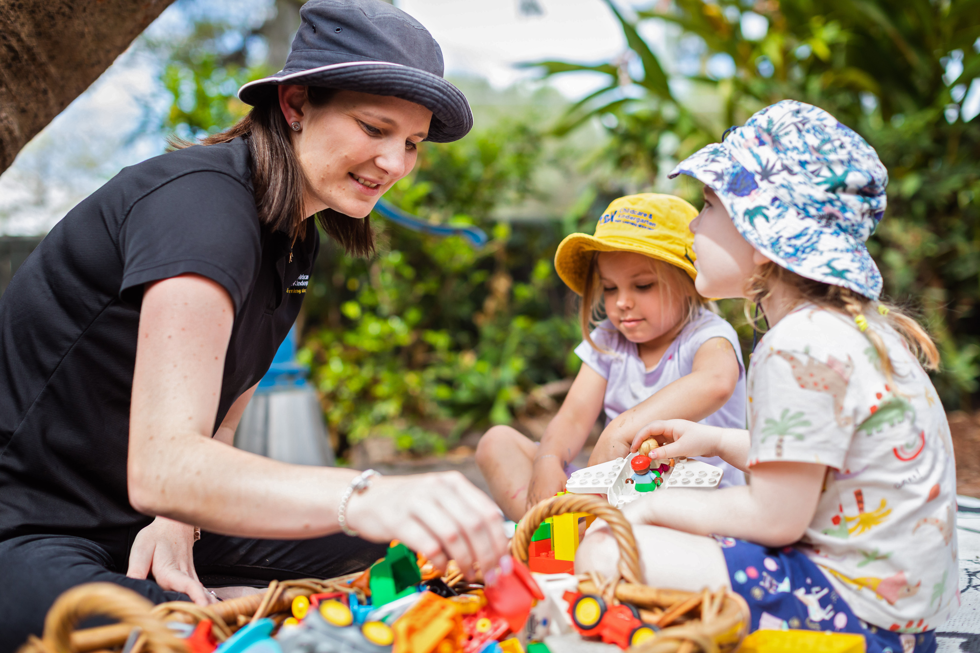 Josie and two kindy children playing outside