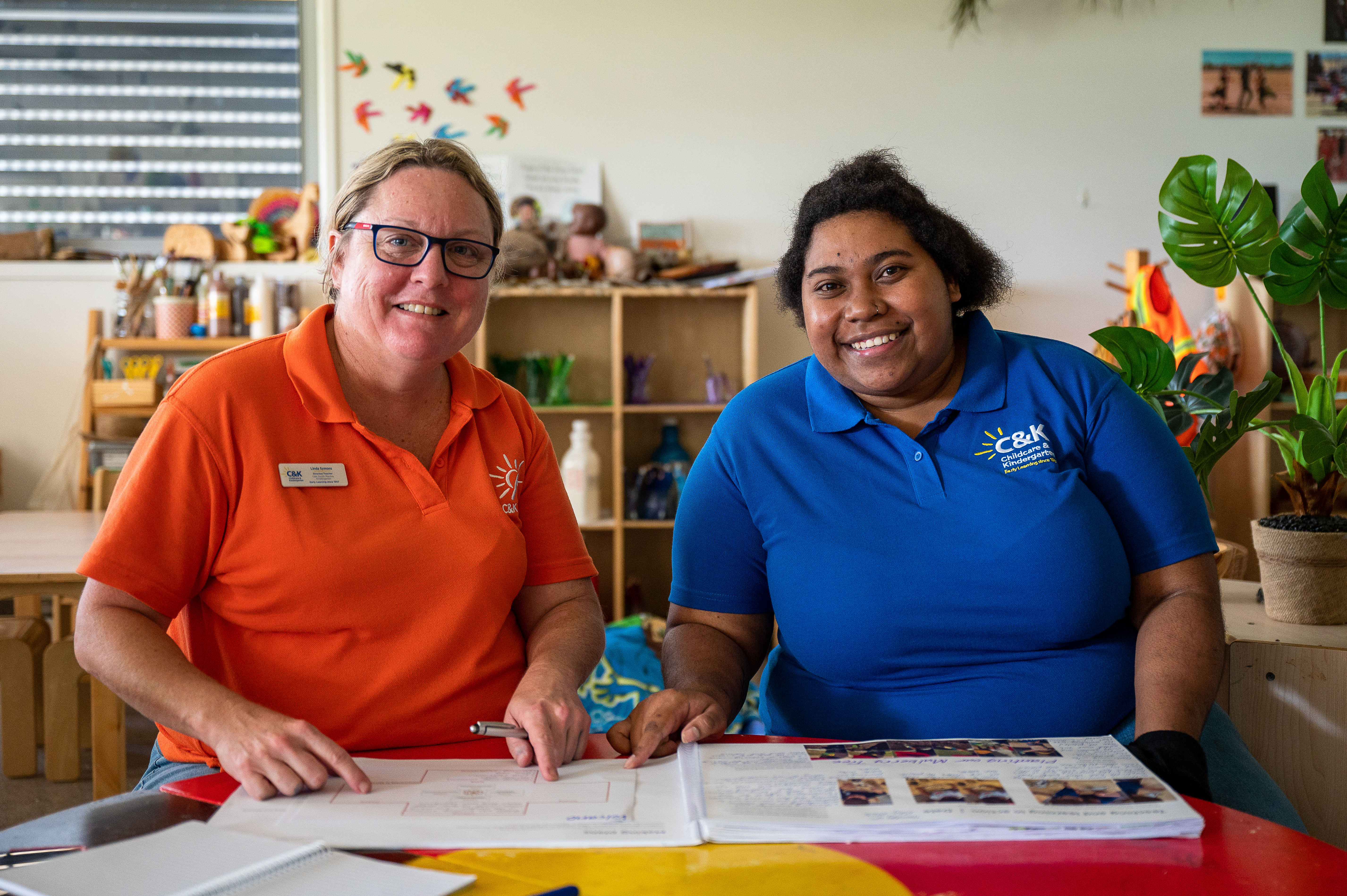 An educator and student looking at camera and smiling.