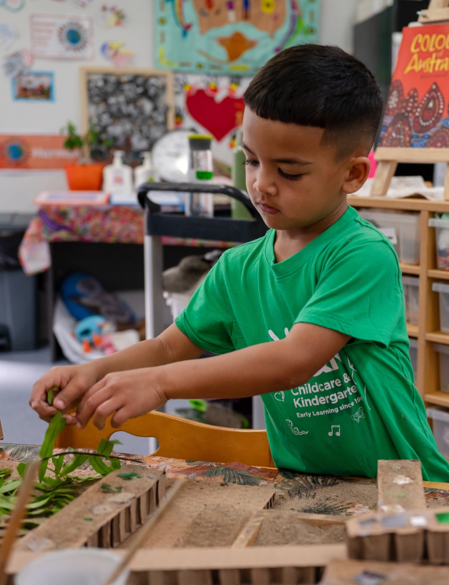 Kindy child creating at a table