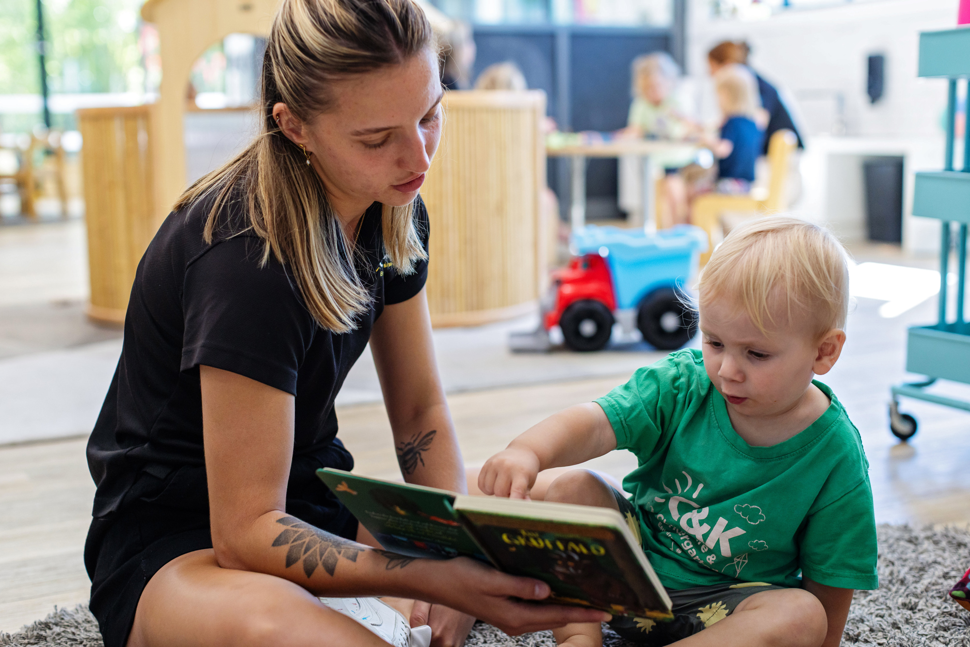 Educator reading with toddler