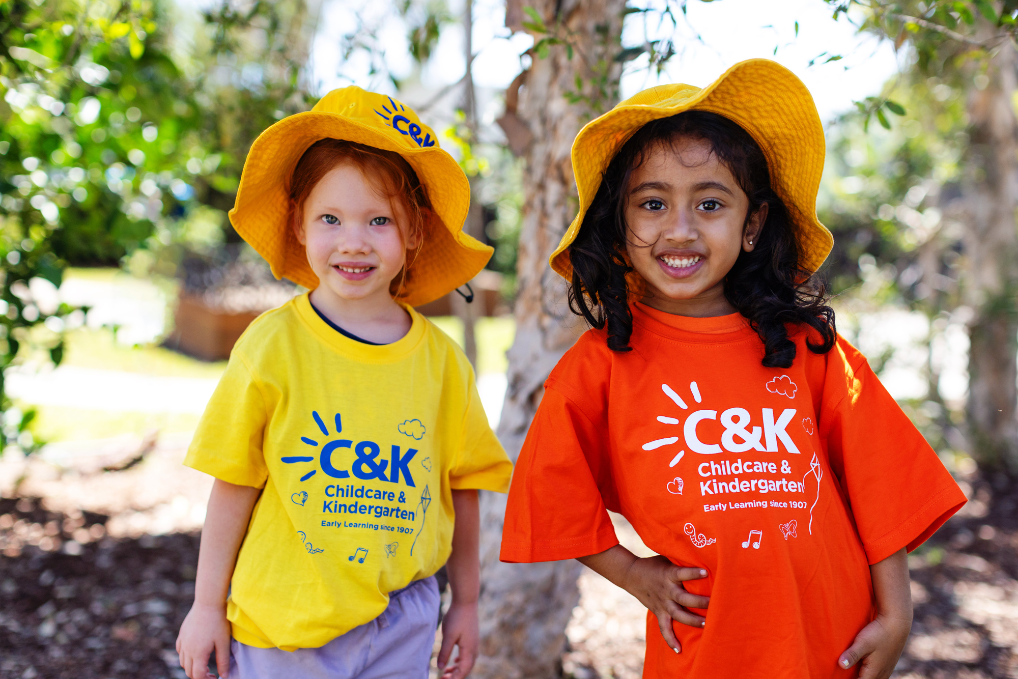 Two smiling children outside