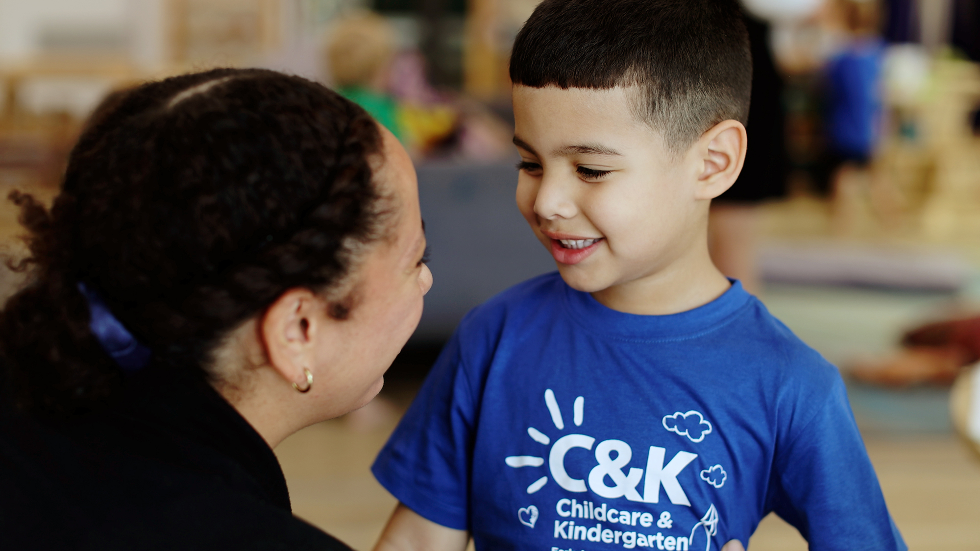 Child smiling at educator