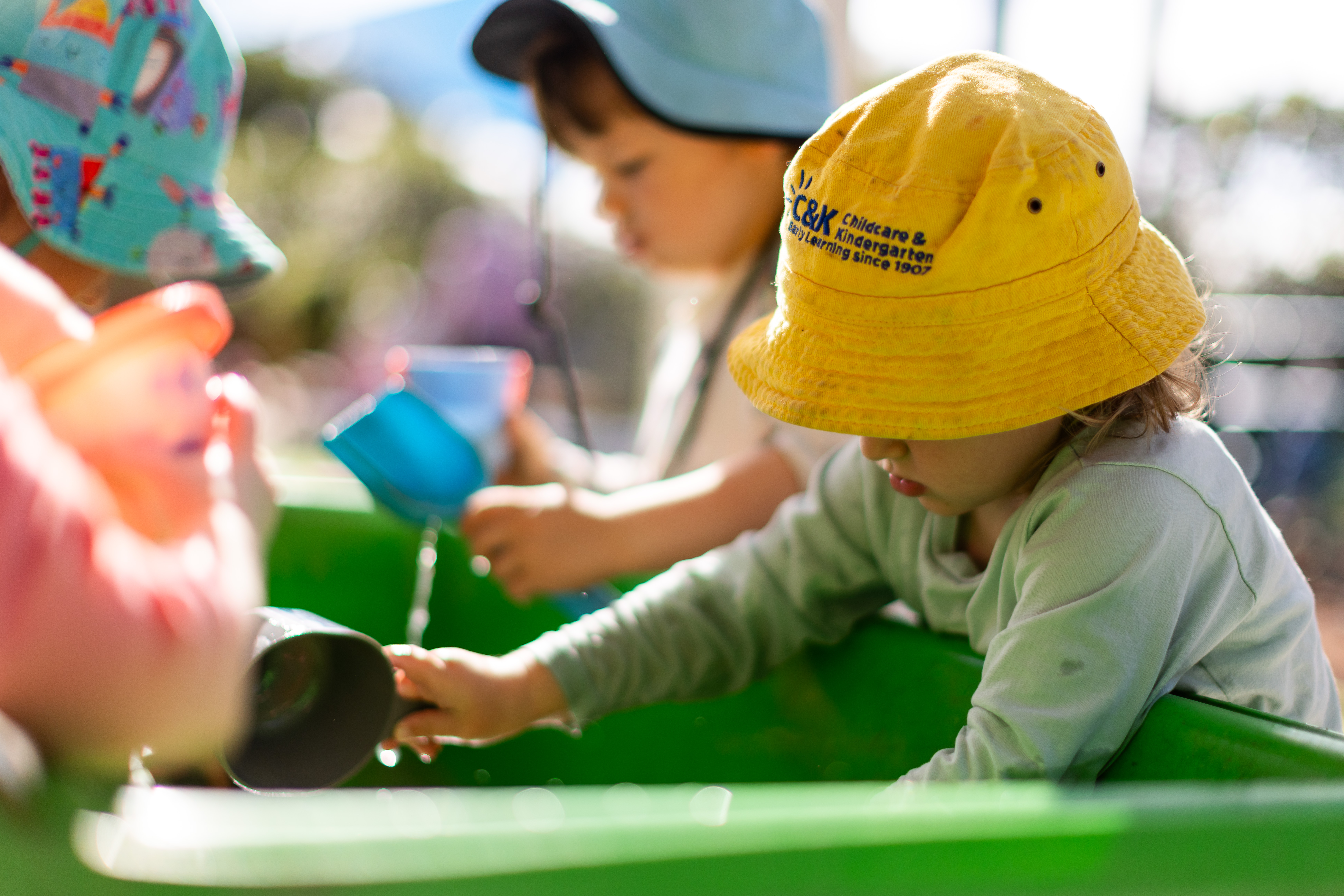 Children playing in the water tray outside