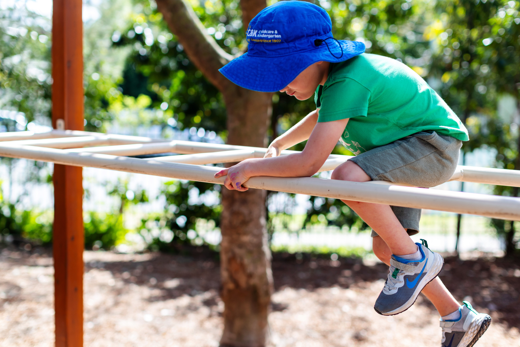 Child climbing on monkey bars outside