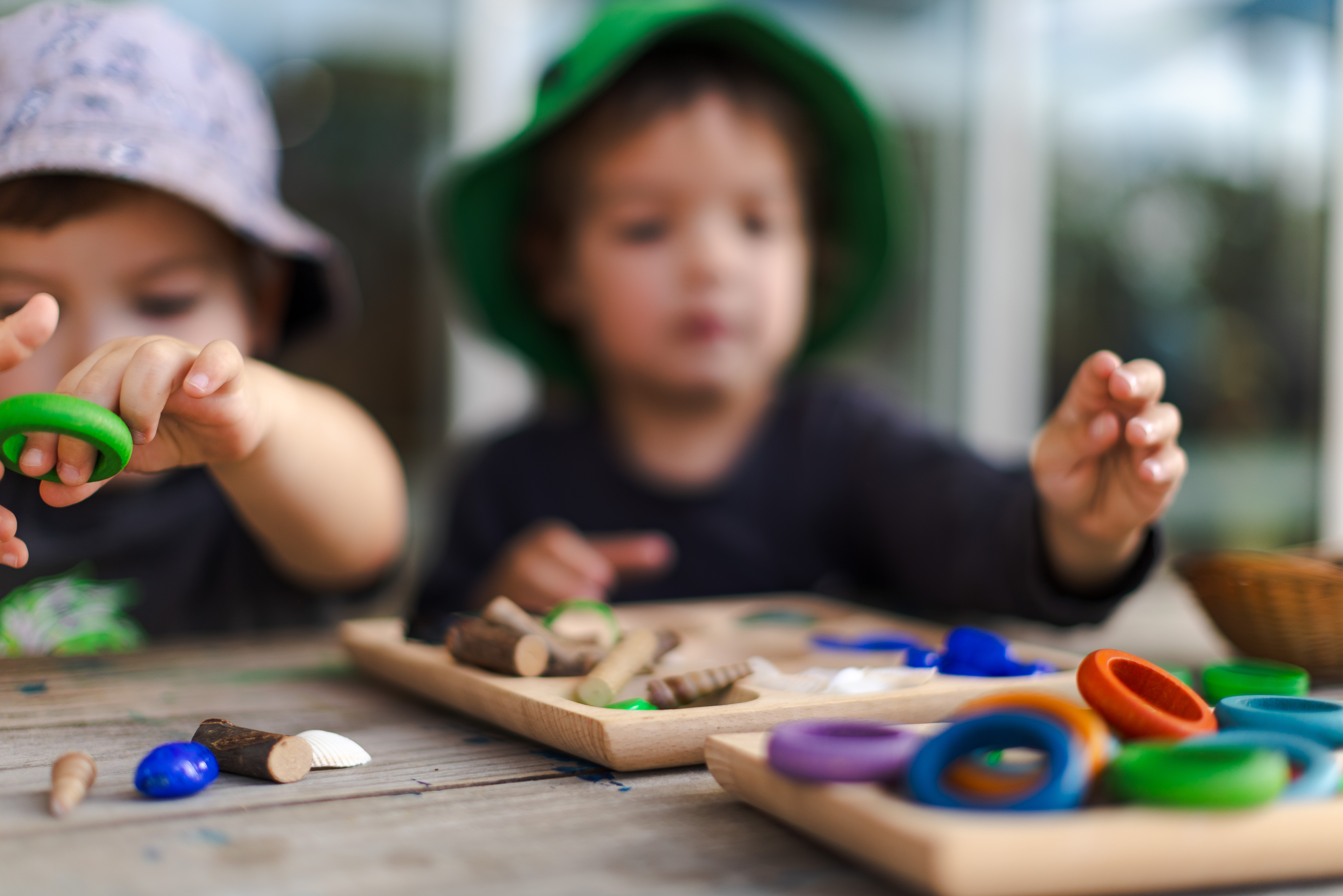 Toddlers playing with colourful loose parts