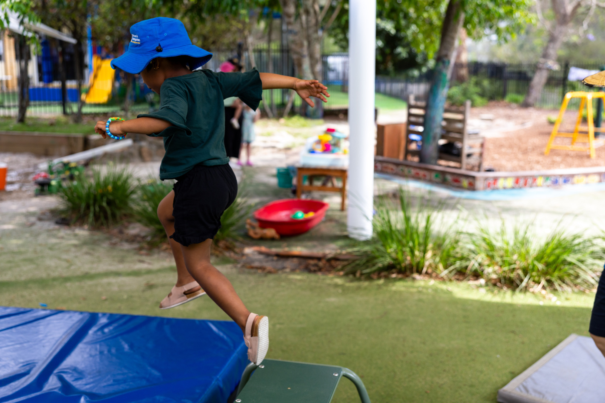 Child jumping on the obstacle course outside