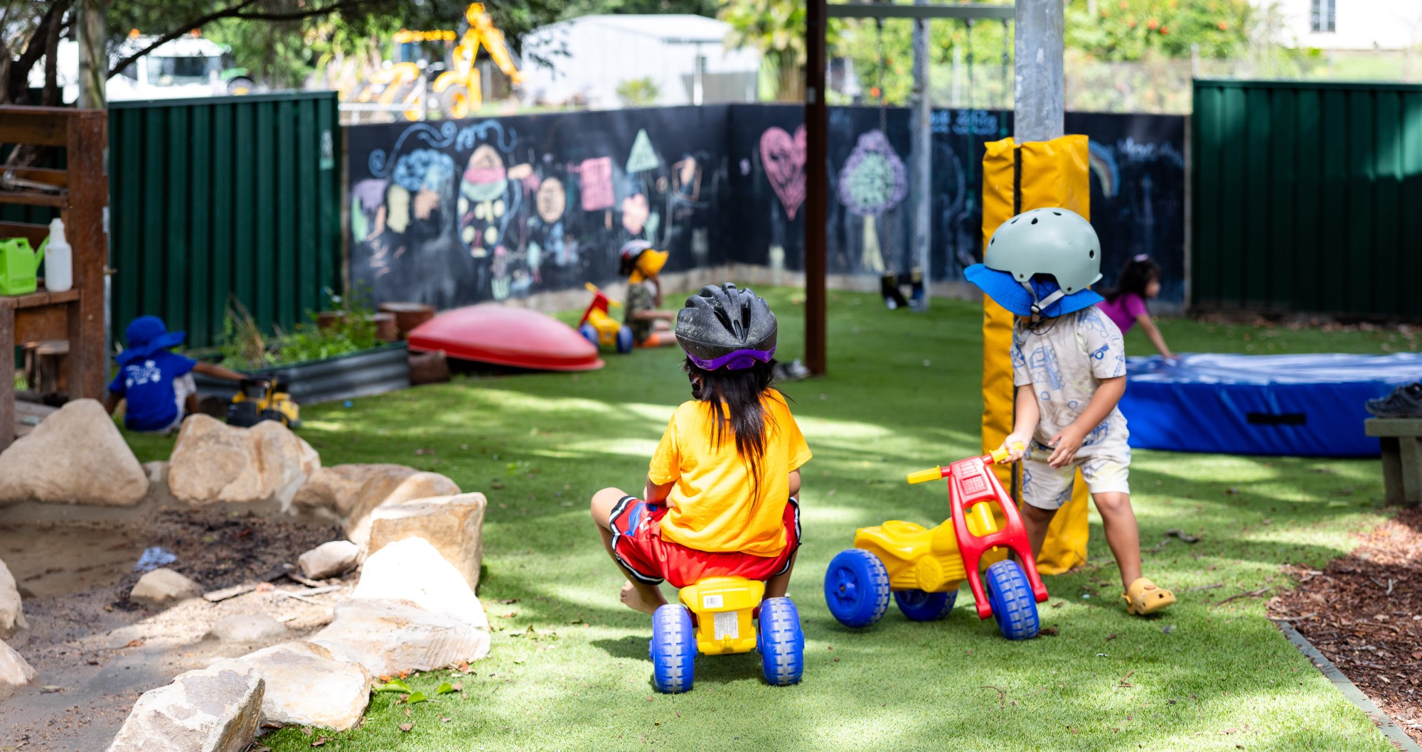 Children playing on tricycles outside