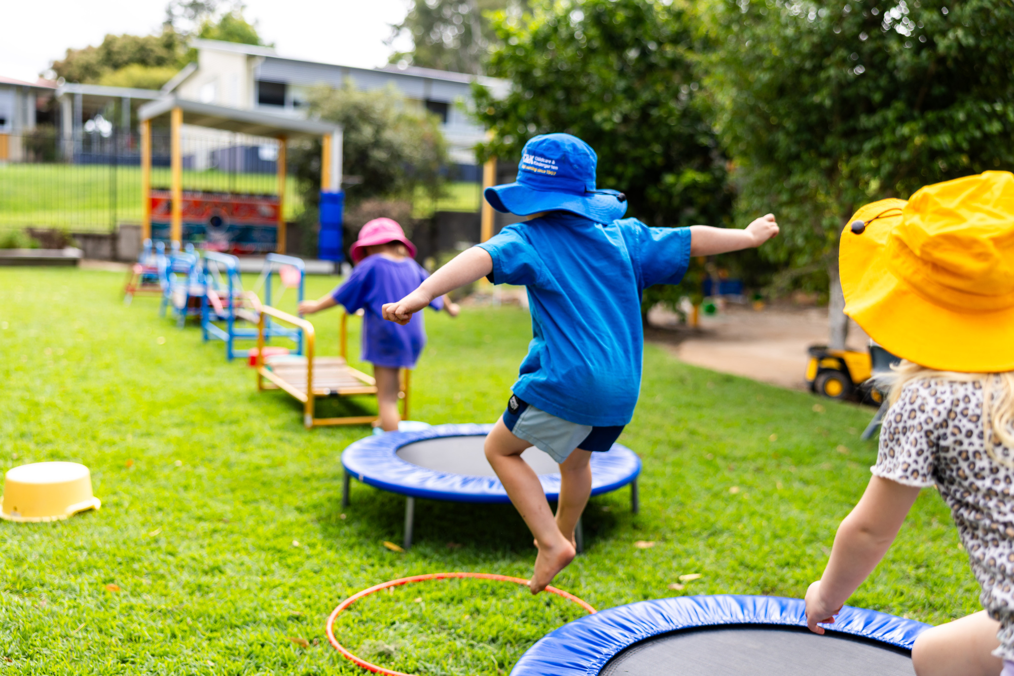 Kindy children playing outside on obstacle course
