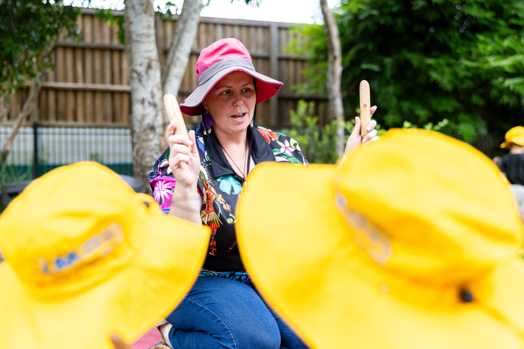 Educator at C&K Woodford holding First Nations clapping sticks
