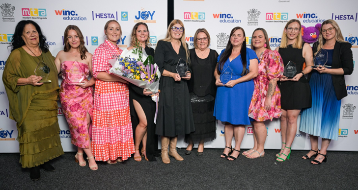 The Award Winners lined up holding their trophies and flowers with CEO Dr Sandra Cheeseman