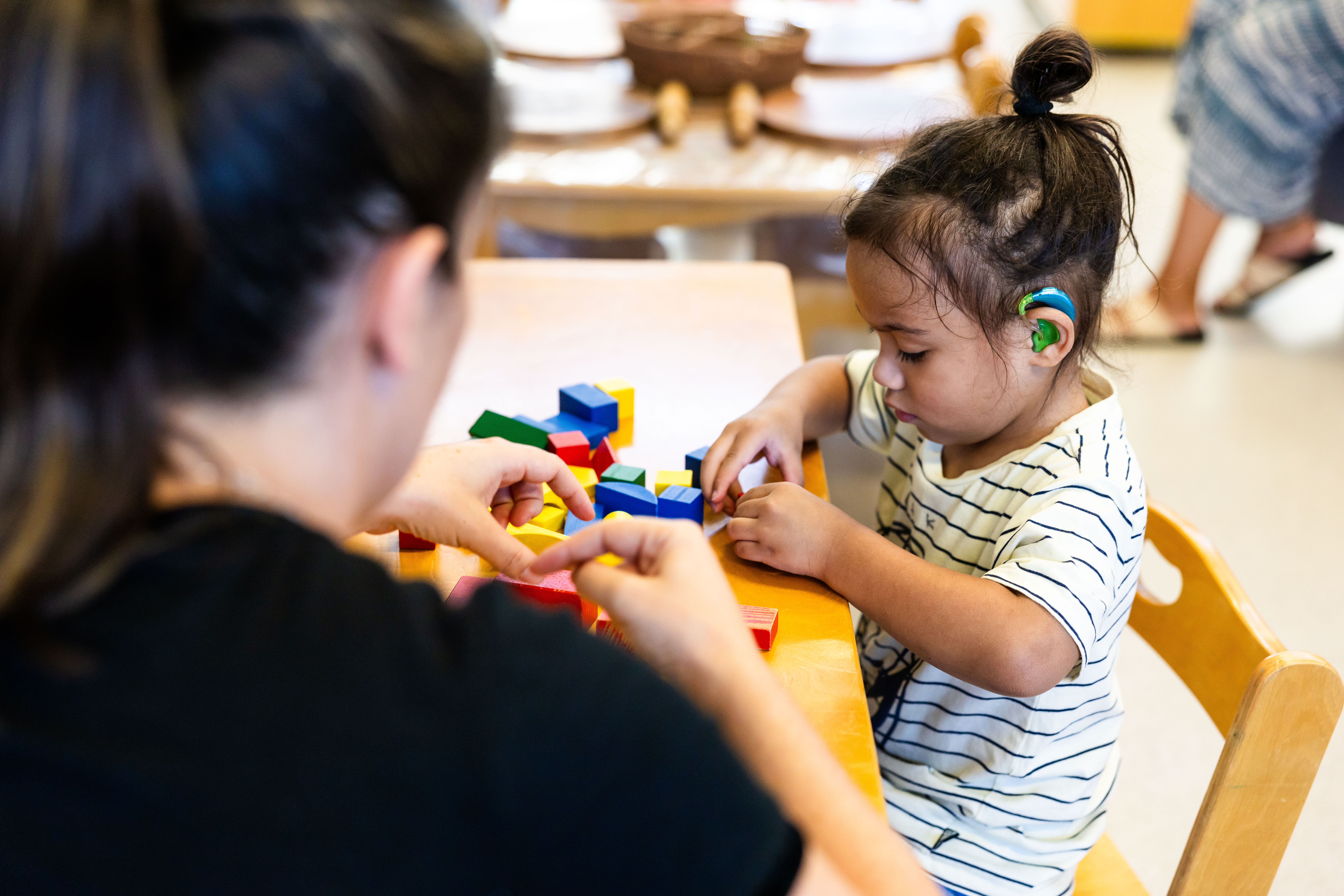 Child with cochlear implant playing with blocks