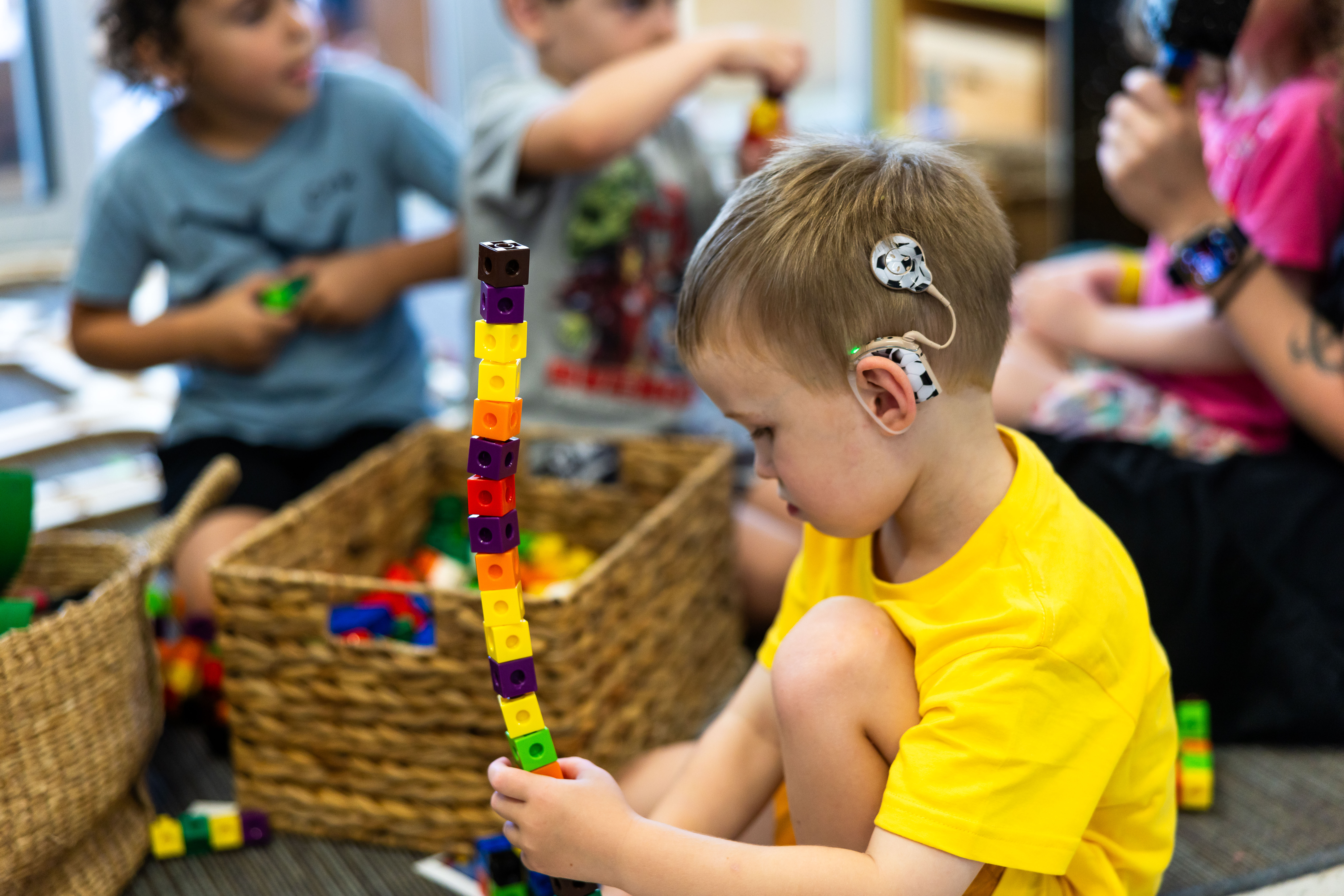 Child with cochlear implant building blocks