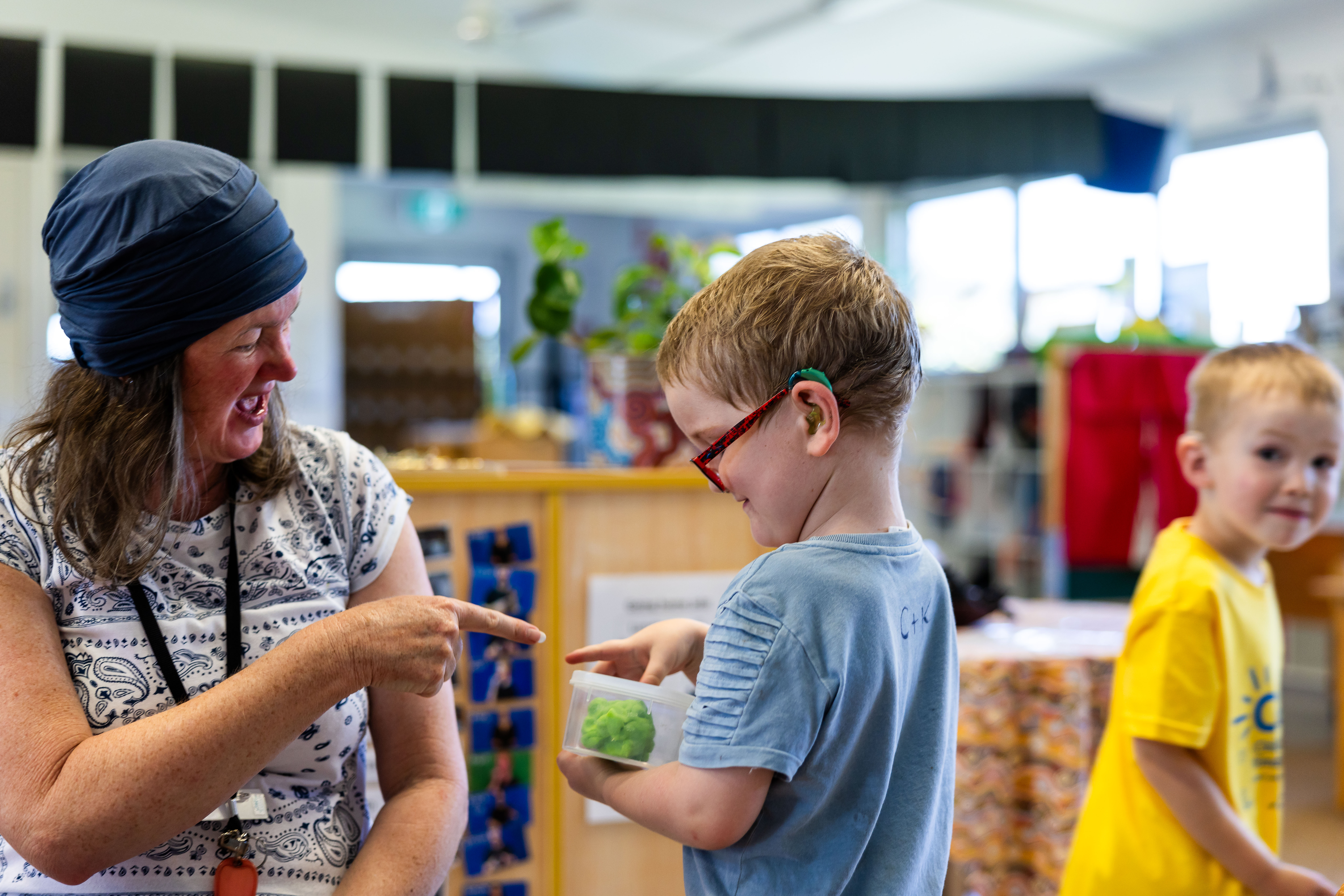 AUSLAN educator signing to child with cochlear implant