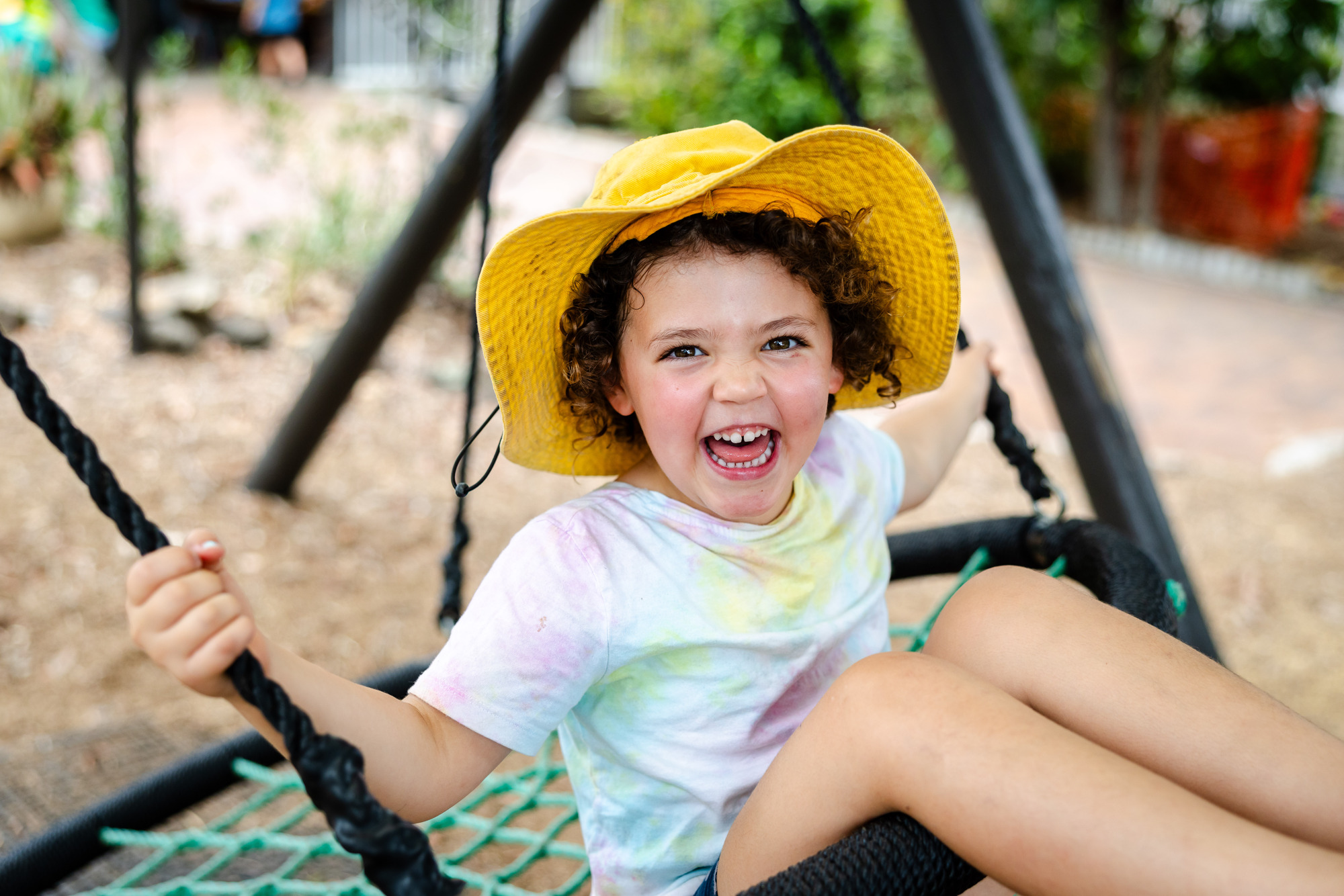 child smiling on swing