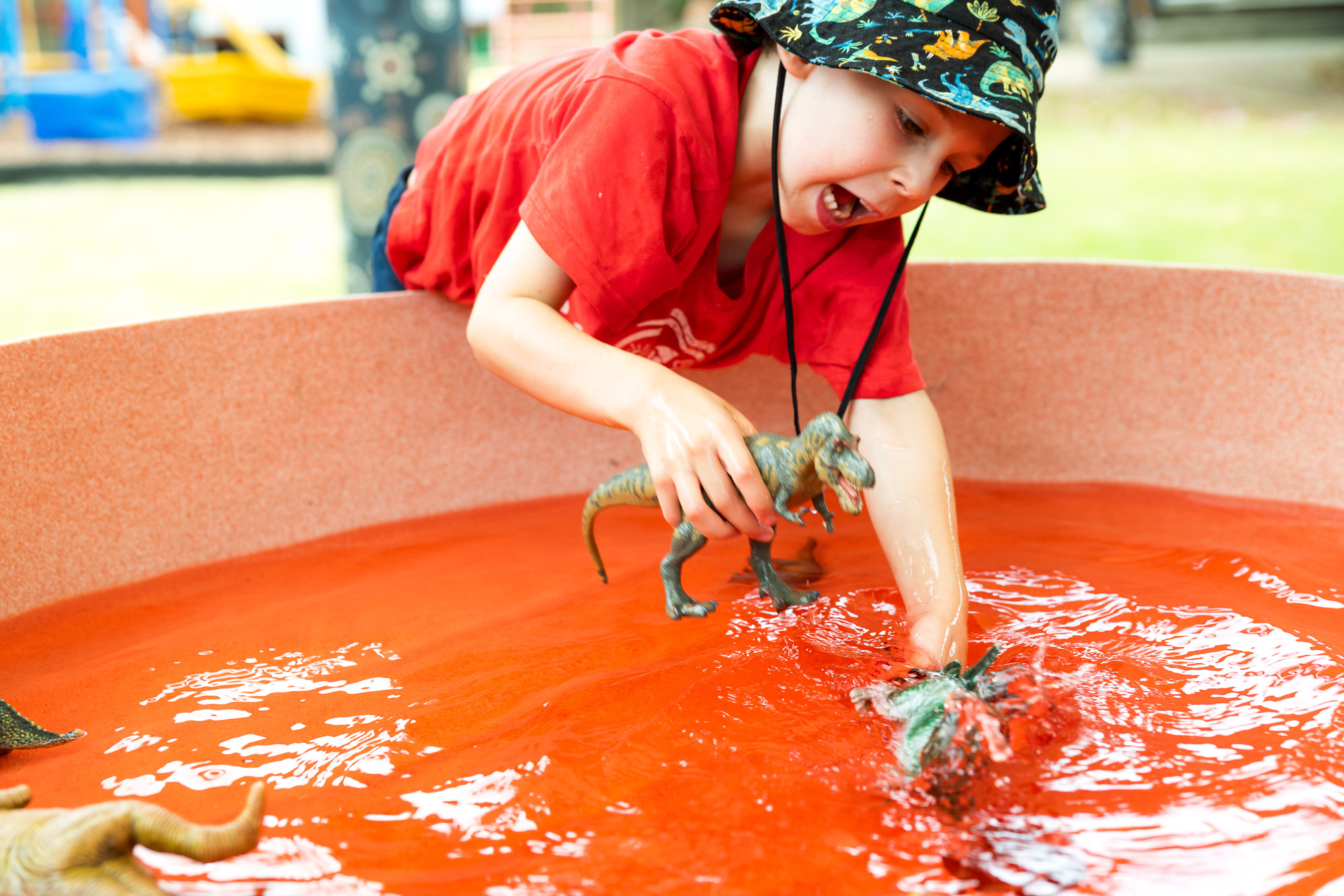 child playing in water tray