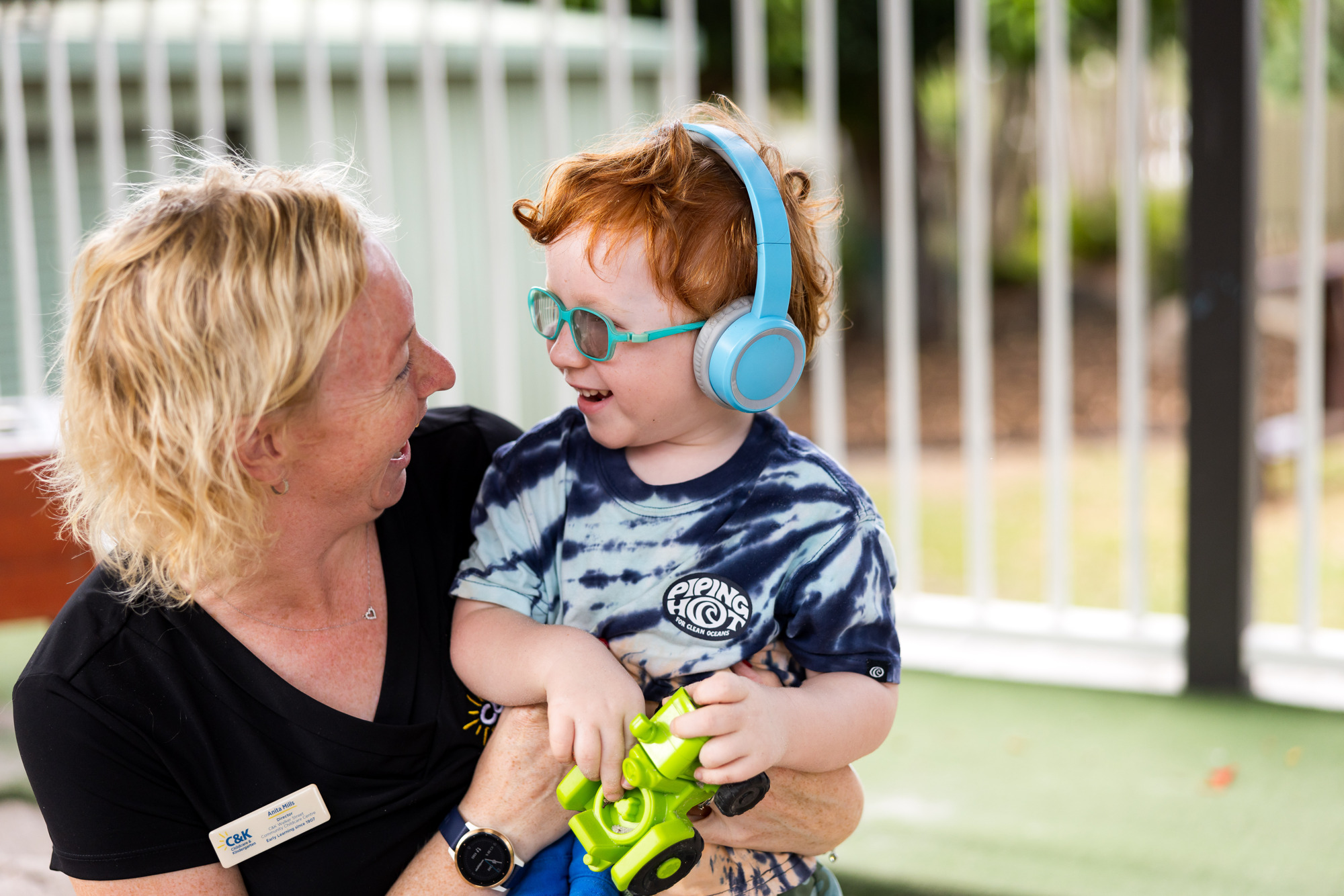 Educator and child wearing ear protection