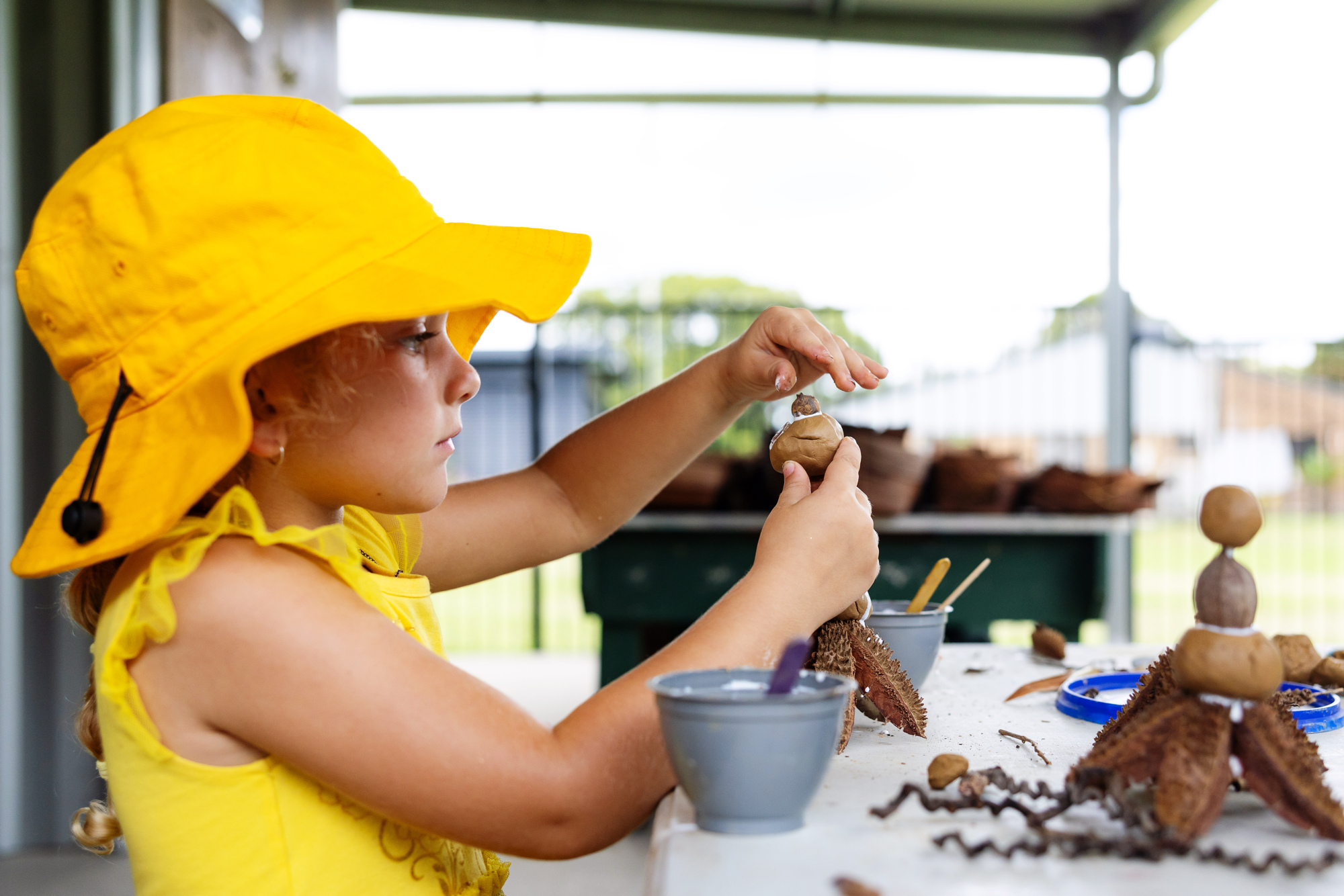 C&K Maleny - child playing with clay and natural loose parts