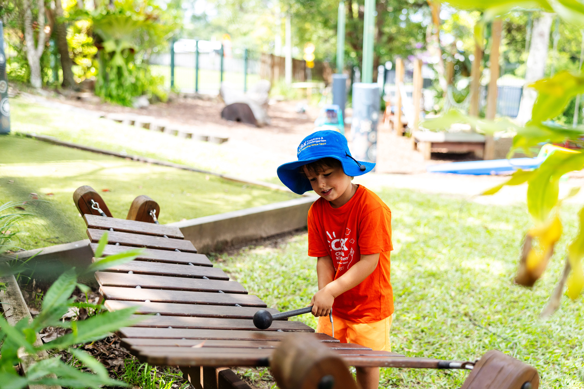 C&K Mooloolah - child playing wooden xylophone