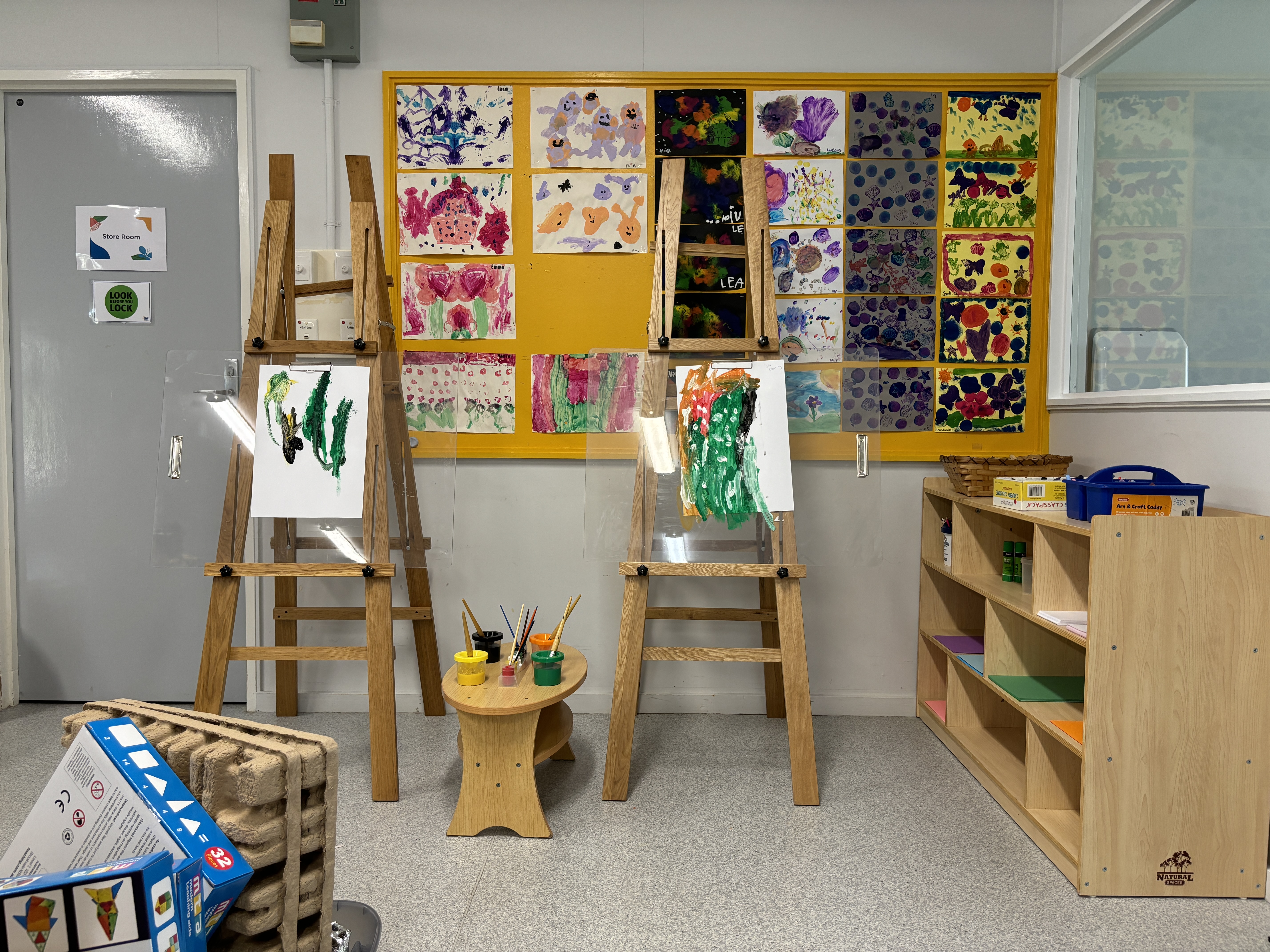 Two art easels with colourful artwork on display