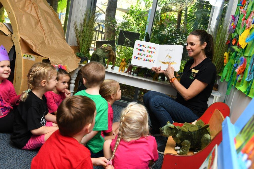 educator reading book to children