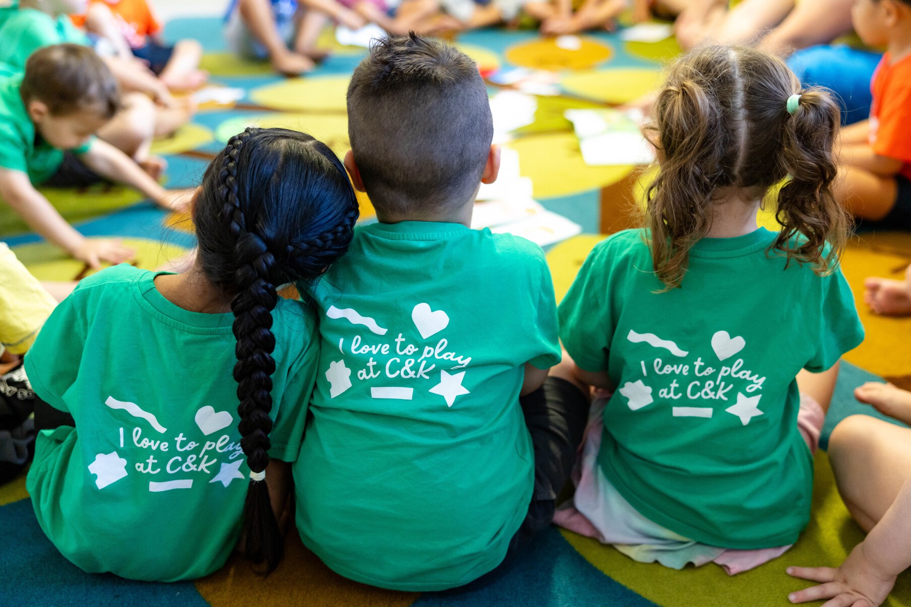C&K Augusta - 3 children sitting on the mat in the classroom