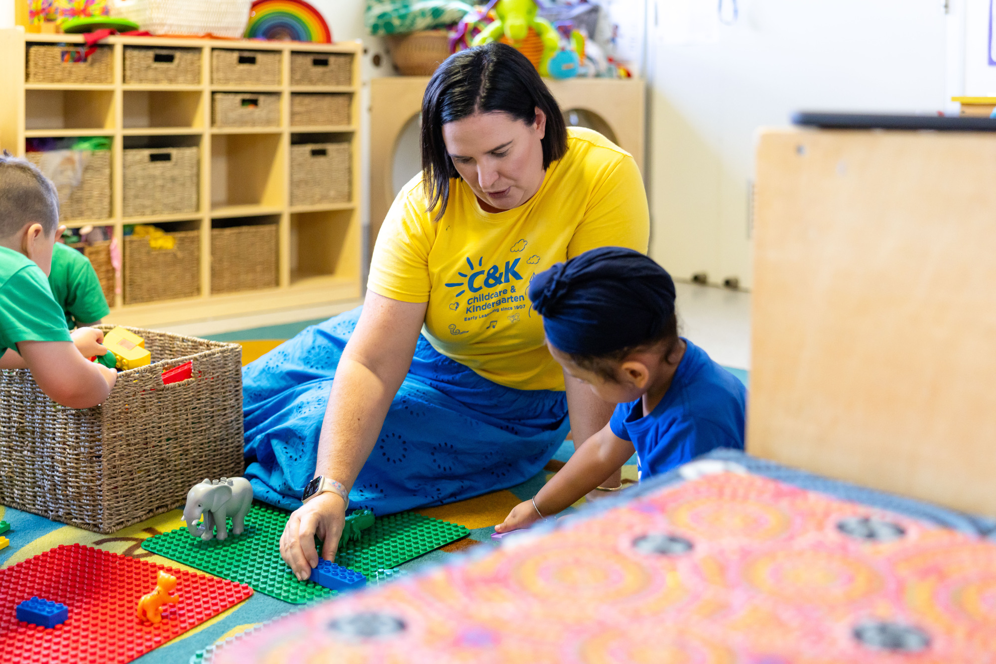 C&K Augusta - educator and child playing with building blocks