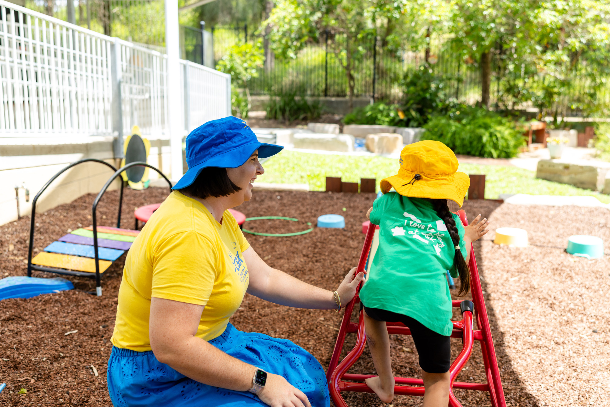 C&K Augusta - educator helping a child on the obstacle course