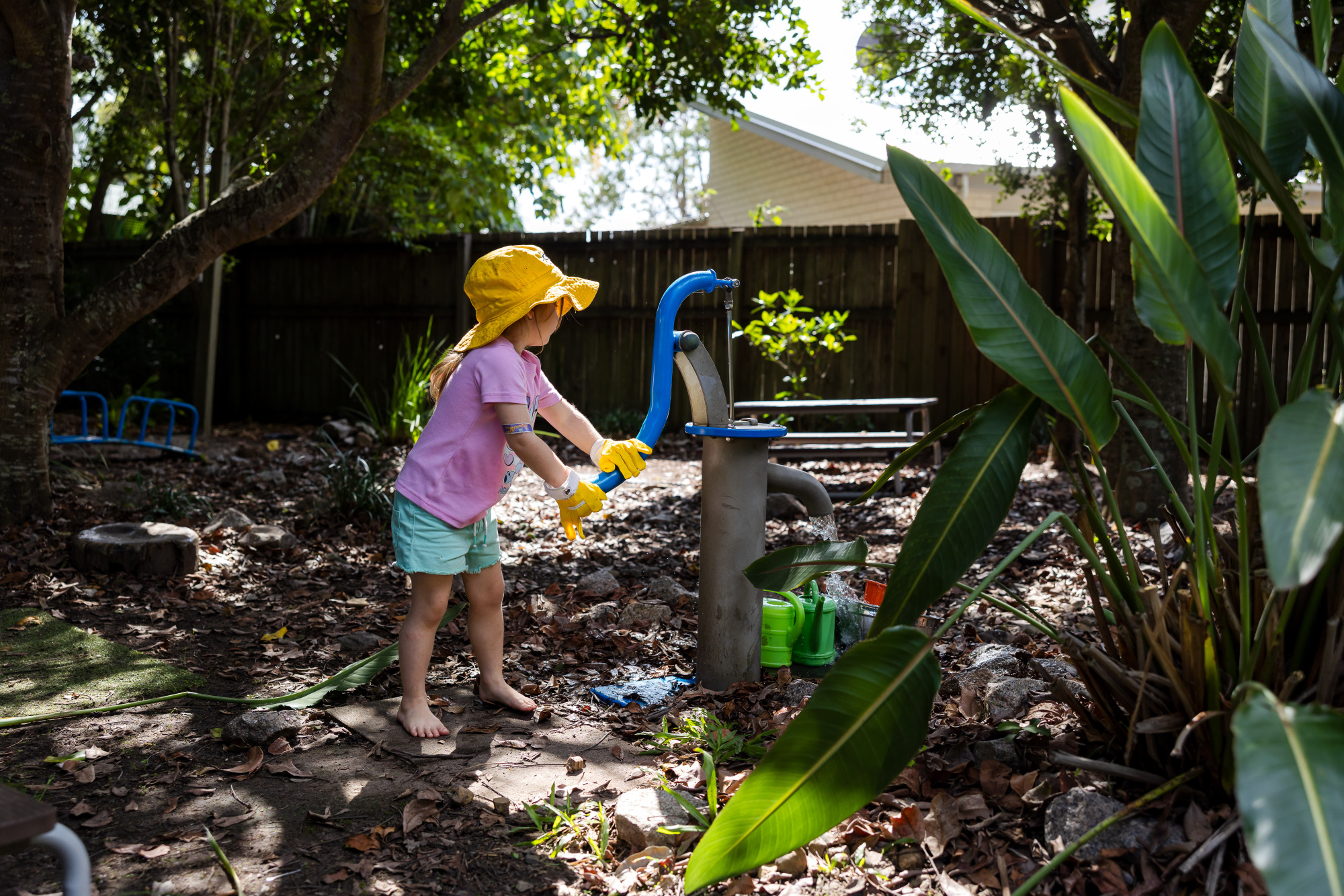 C&K Beachmere - child using the water pump to fill a watering can